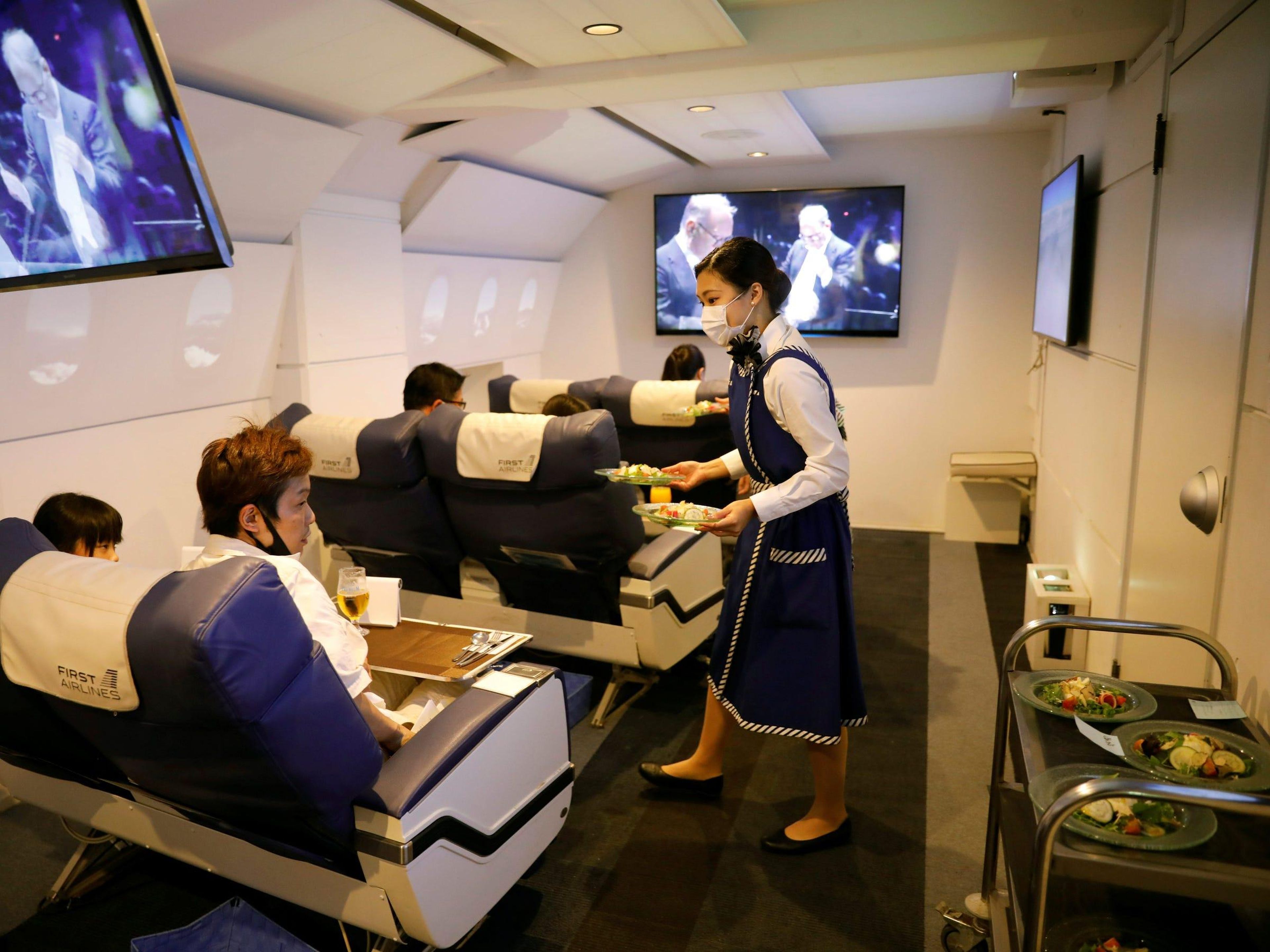A staff dressed as a flight attendant serves meals to customers at First Airlines in Tokyo, Japan on August 12, 2020. Kim Kyung-Hoon/Reuters