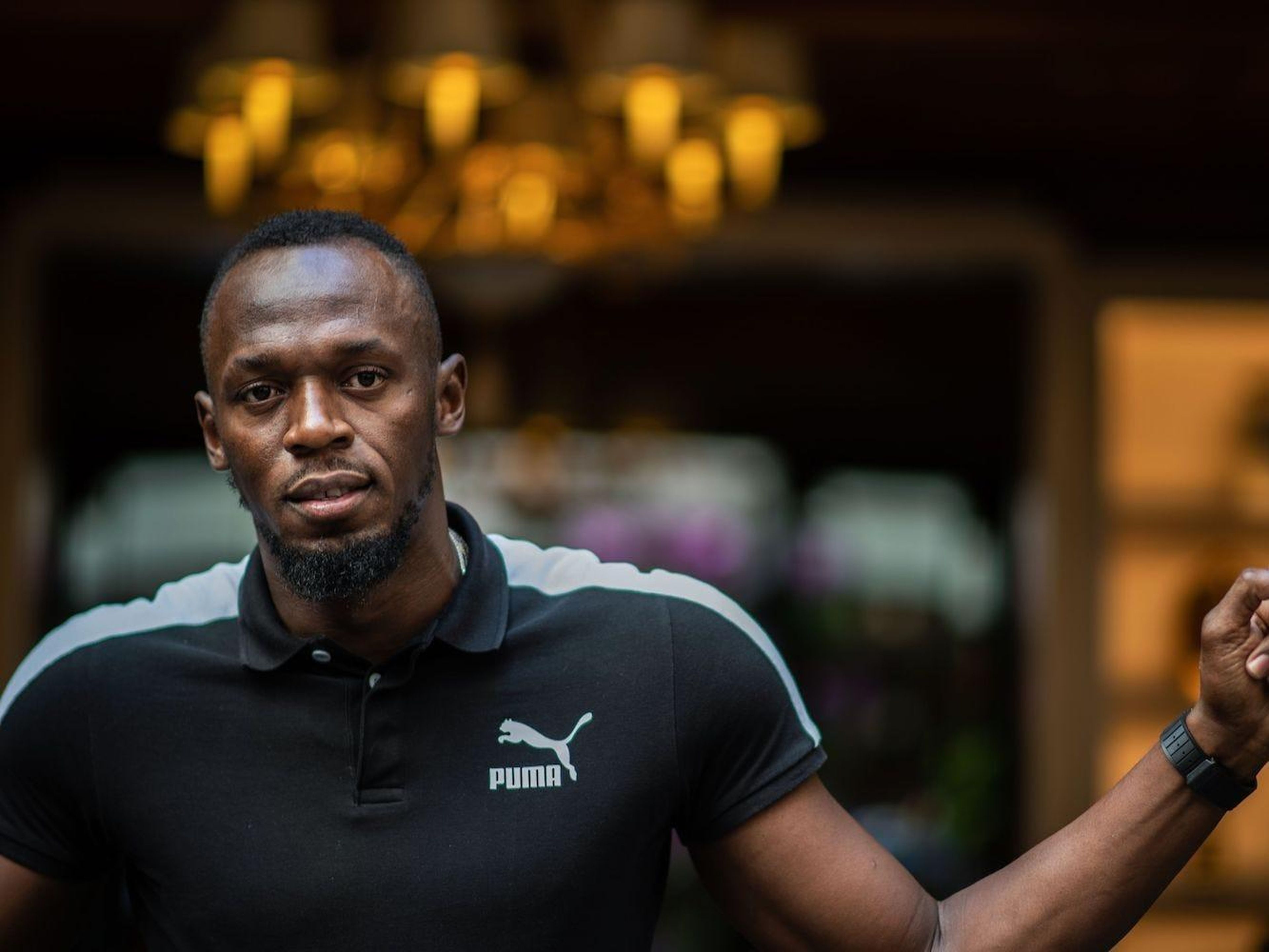 Jamaican Olympic sprinter Usain Bolt poses during a photo session as he launches a new brand of electric scooters named "Bolt" in Paris, on May 15, 2019. MARTIN BUREAU/AFP via Getty Images