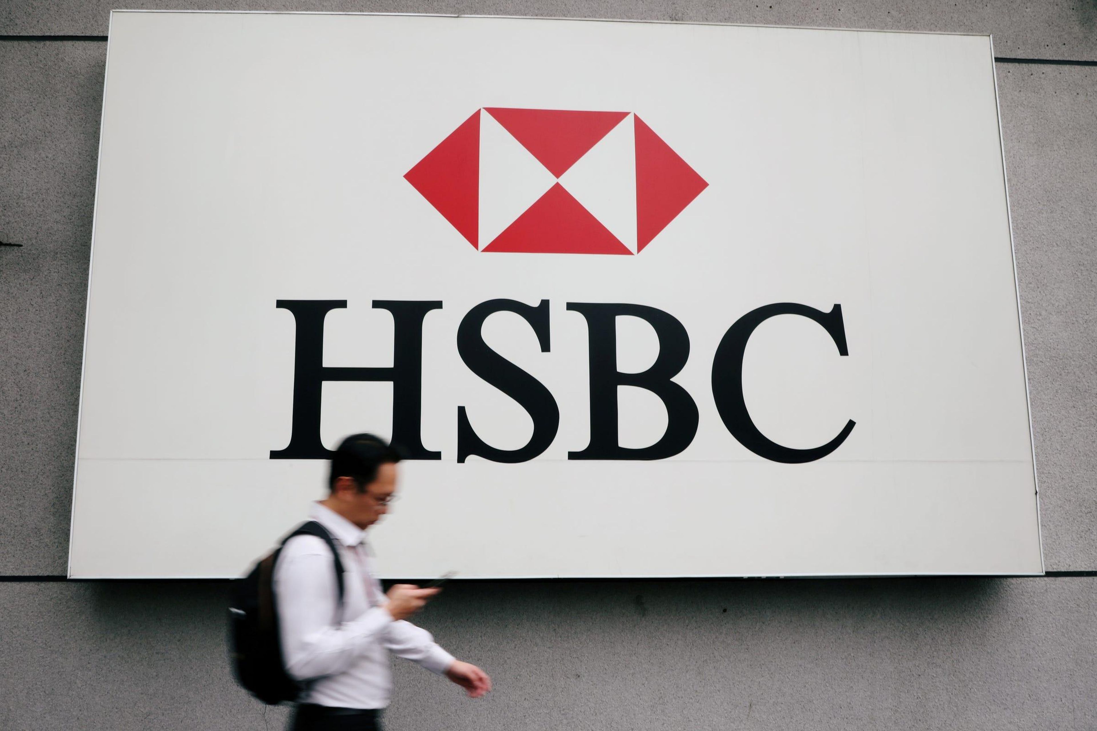 A man walks past a logo of HSBC at its headquarters in Kuala Lumpur. Reuters