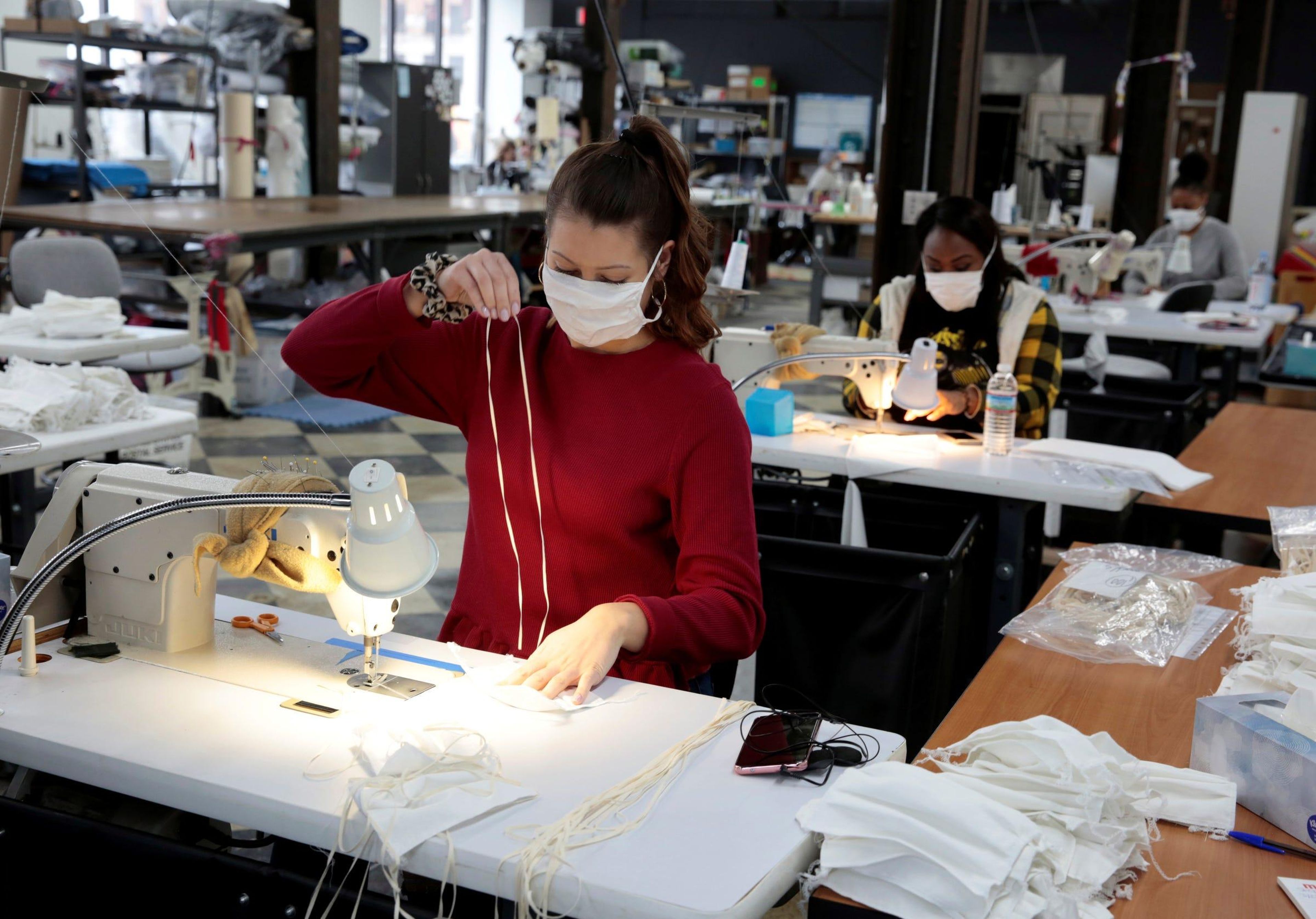 A woman sews hospital masks at the Detroit Sewn facility in Pontiac, Michigan, on March 23, 2020. Rebecca Cook/Reuters