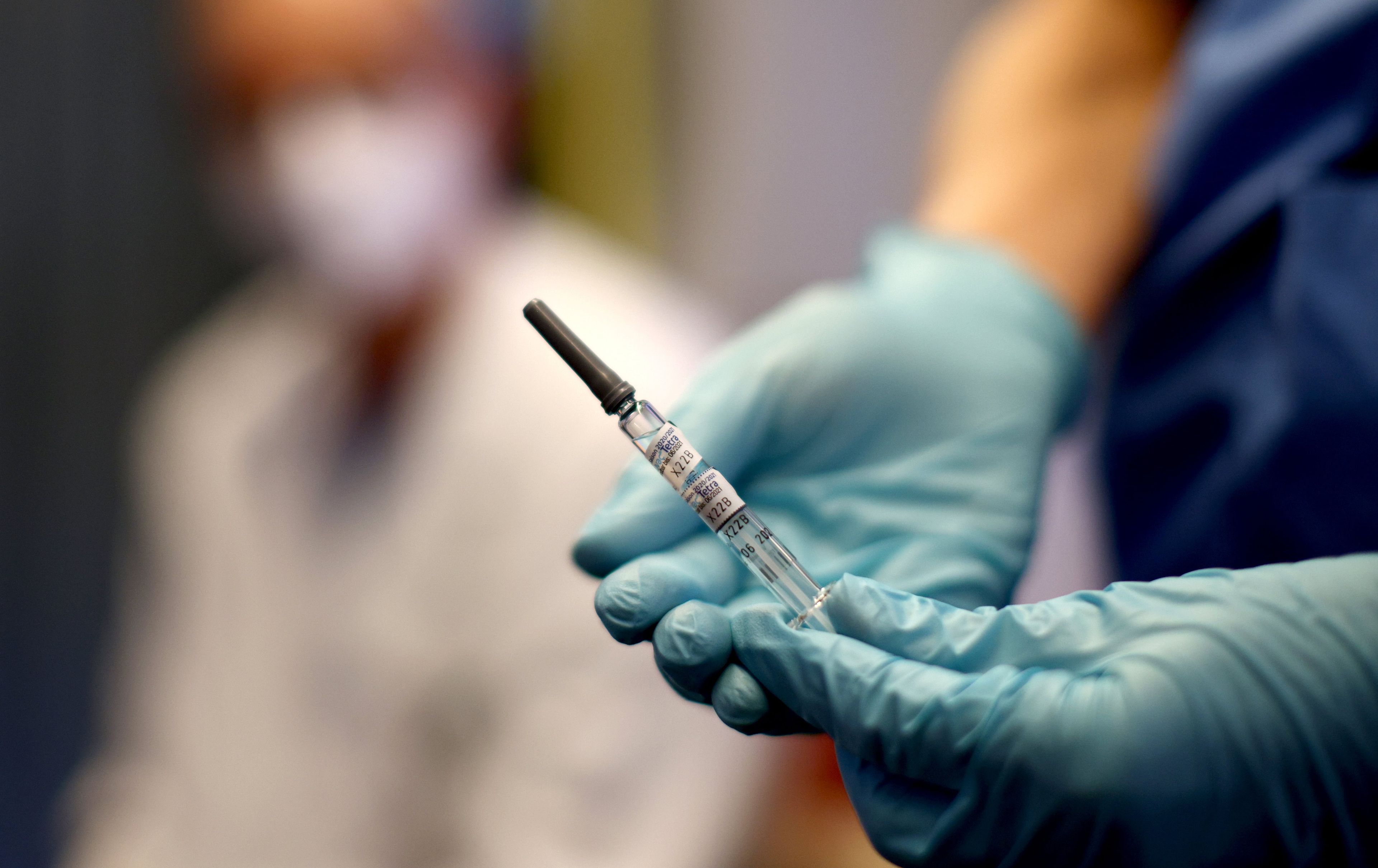 Un sanitario muestra la vacuna del programa gratuito contra la influenza en Viena, Austria.