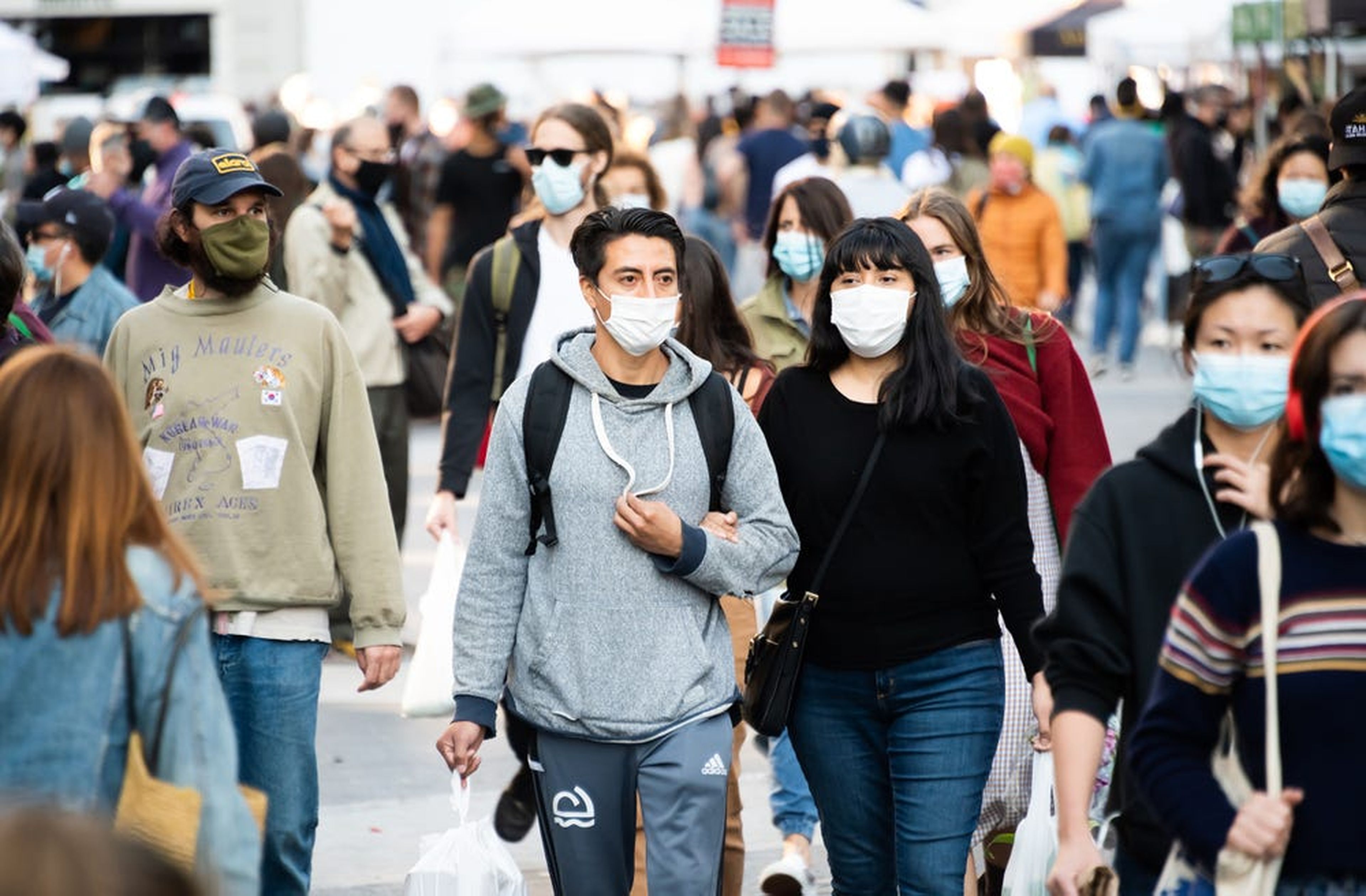 People wear face masks at the Union Square Greenmarket on September 19, 2020, in New York City.
