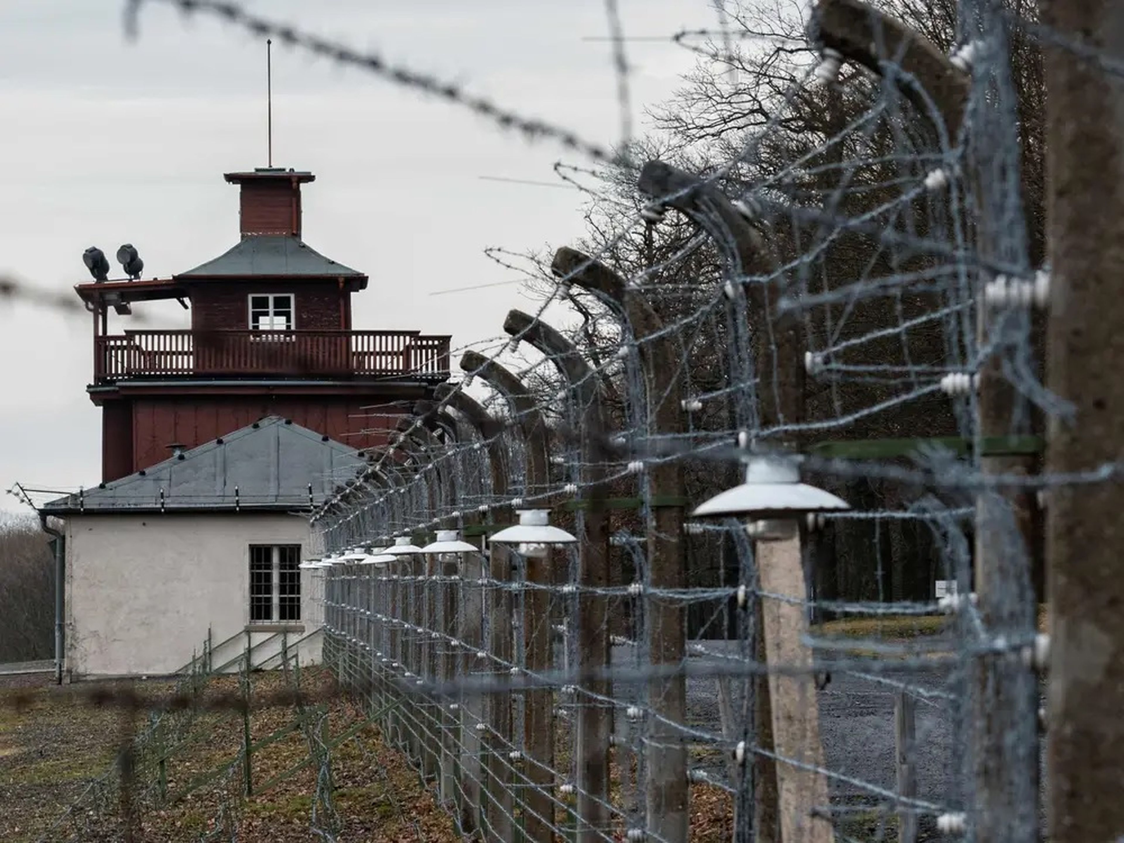 A barbed wire fence encloses the memorial site of Buchenwald near Wiemar, Germany, on January 27, 2020.