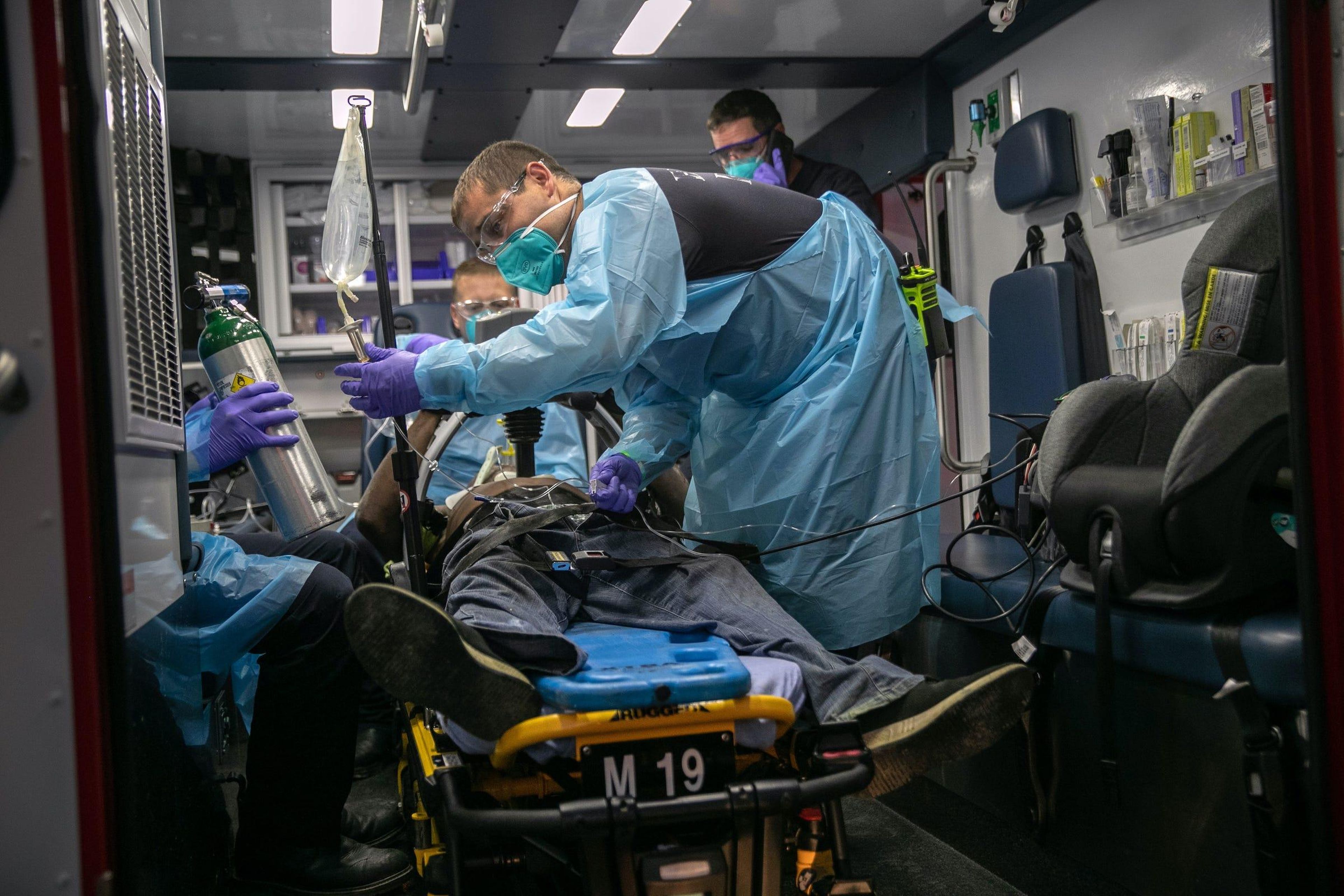 Houston Fire Department medics transport a man to a hospital after he suffered cardiac arrest on August 11, 2020 in Houston, Texas. Heart failure is a frequent result of COVID-19. Firefighters and medics wear protective masks on all medical calls, whether