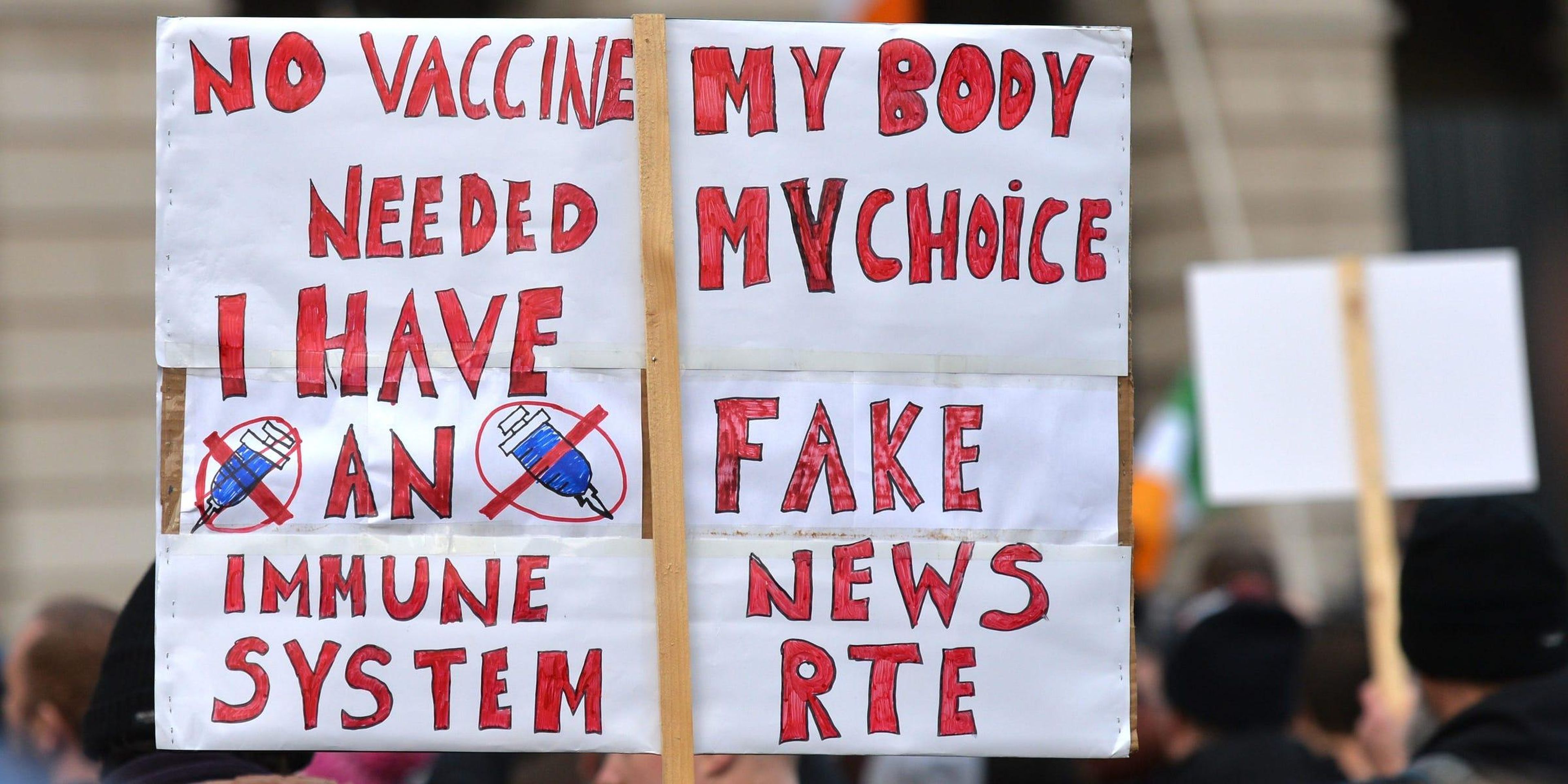 A protester holds a placard during the Irish Freedom Party an anti-vaccination and anti-lockdown rally outside the Custom House, on day 39 of the nationwide Level 5 lockdown. On Saturday, November 28, 2020, in Dublin, Ireland.