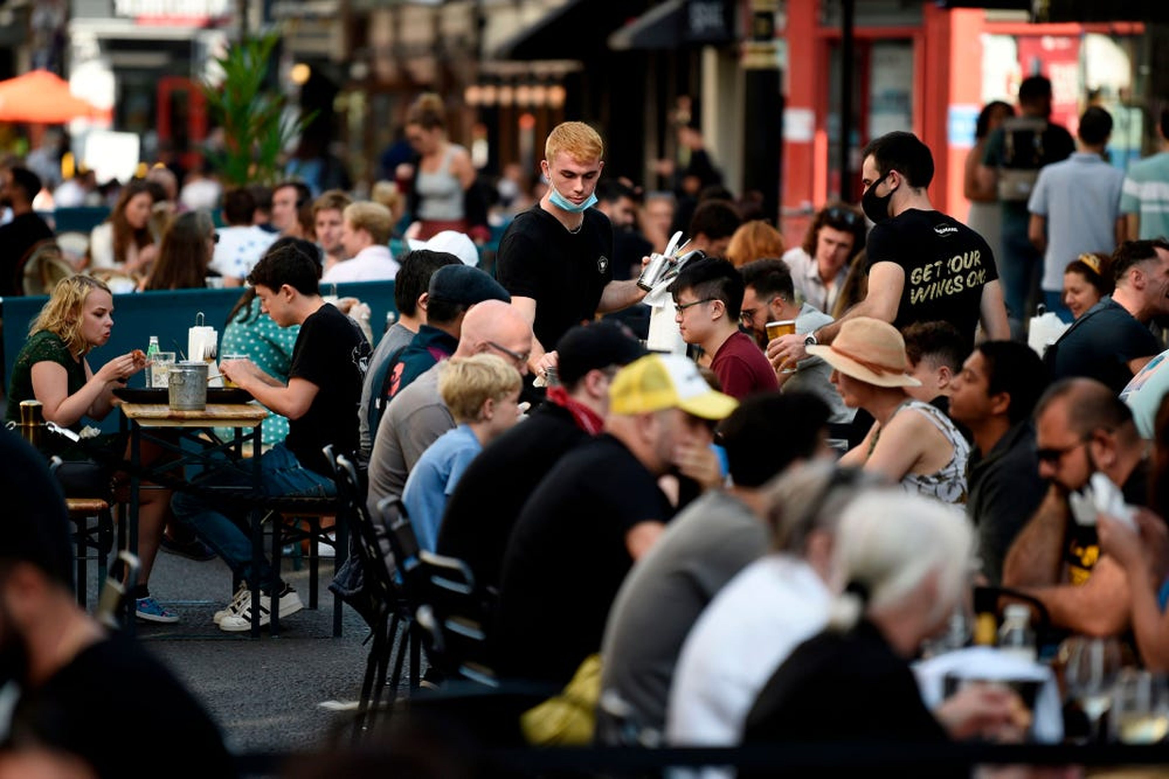 Customers eat lunch at tables outside restaurants in London, England, September 20, 2020.