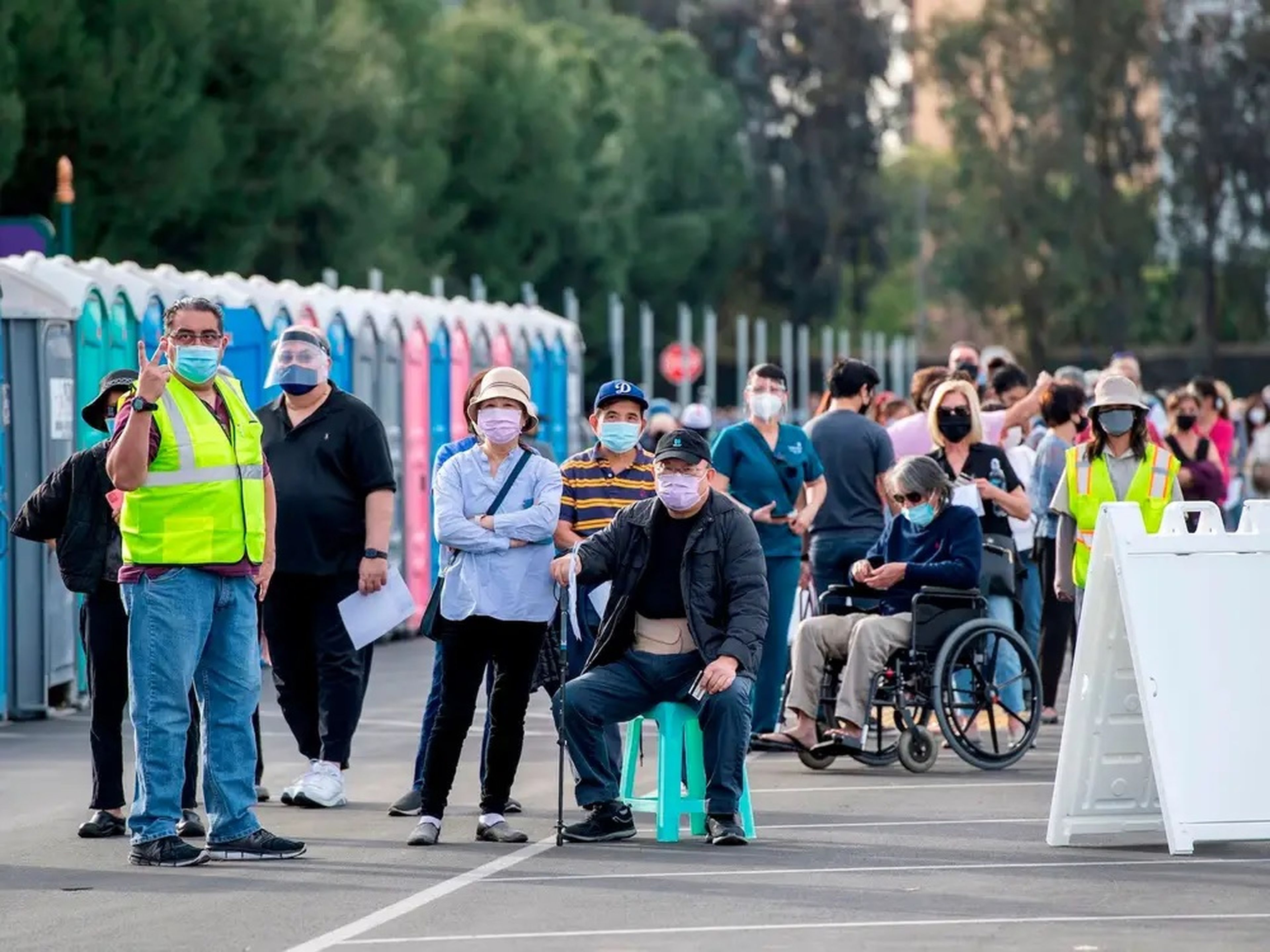 People wait in line in a Disneyland parking lot to receive Covid-19 vaccines on the opening day of the Disneyland Covid-19 vaccination site in Anaheim, California.