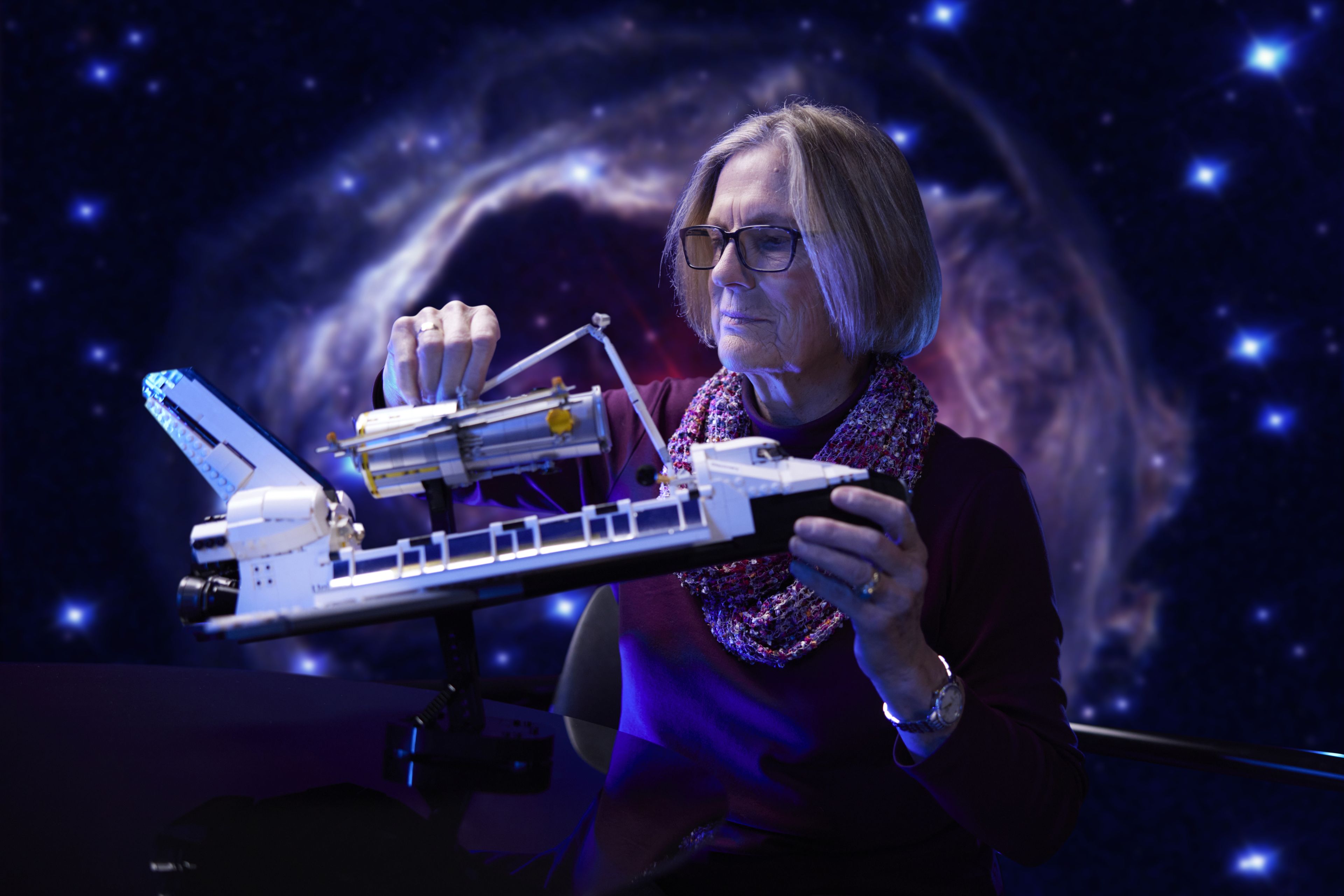 La astronauta Kathryn Sullivan, de la misión original, sostiene el set de Lego.