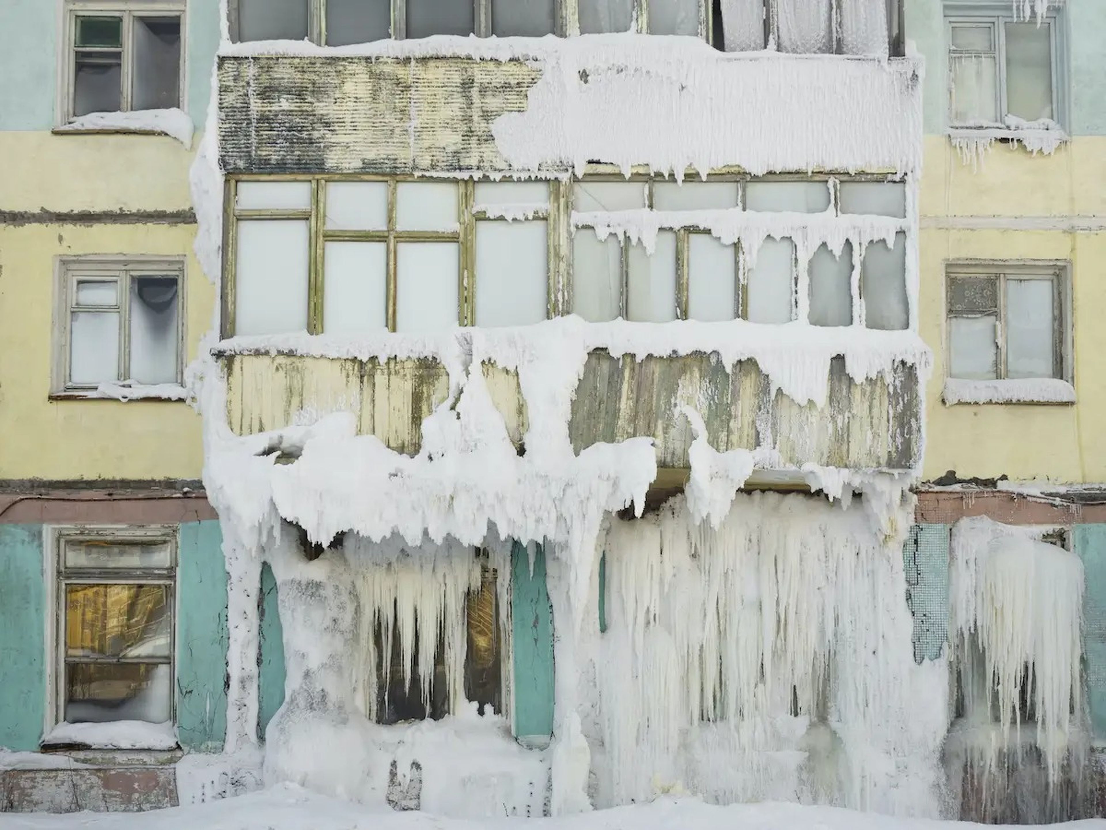 Los edificios, en gran parte abandonados, están cubiertos de nieve y hielo.