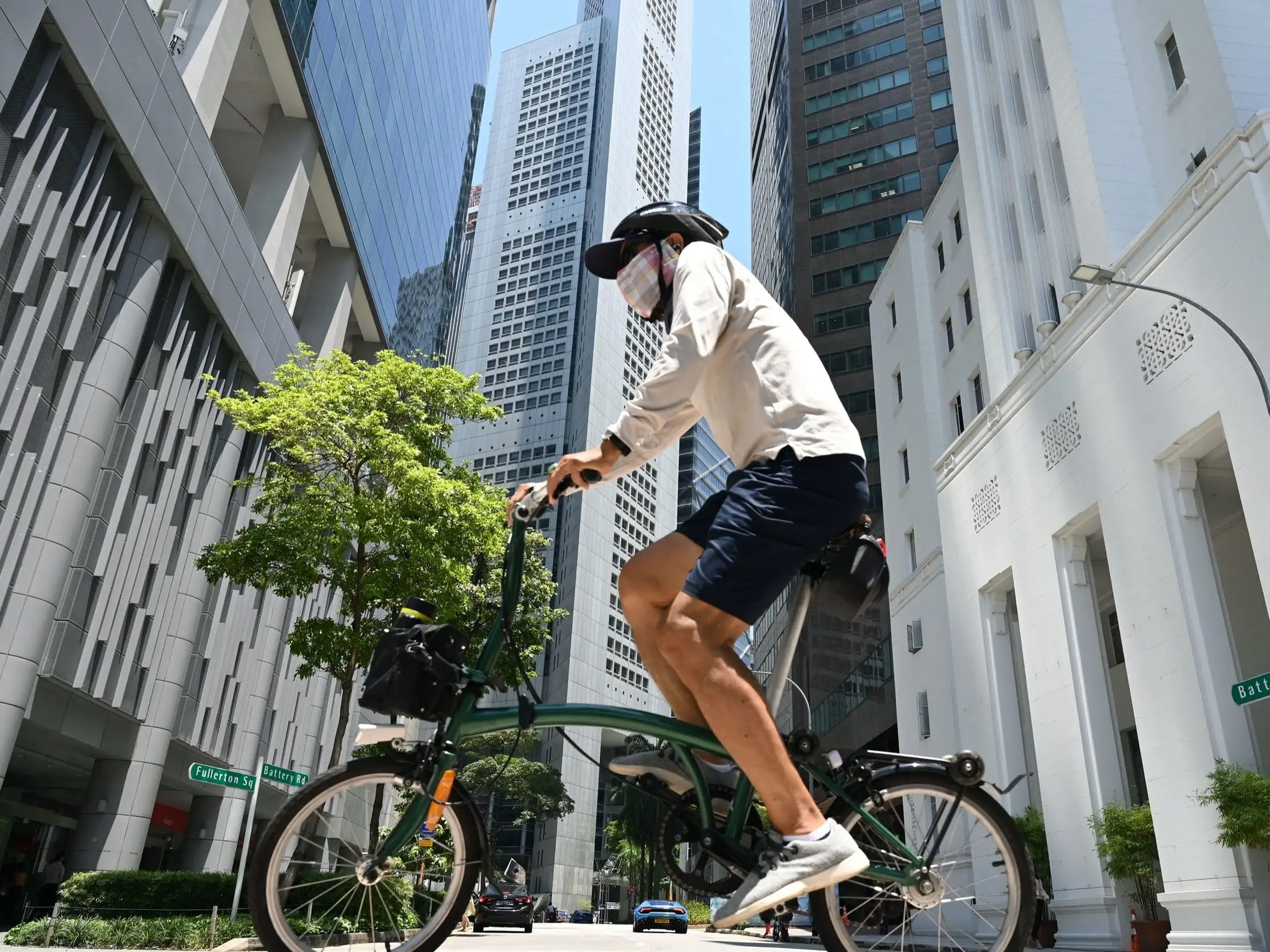 Un hombre monta en bicicleta en el distrito financiero Raffles Place en Singapur el 20 de abril de 2021.