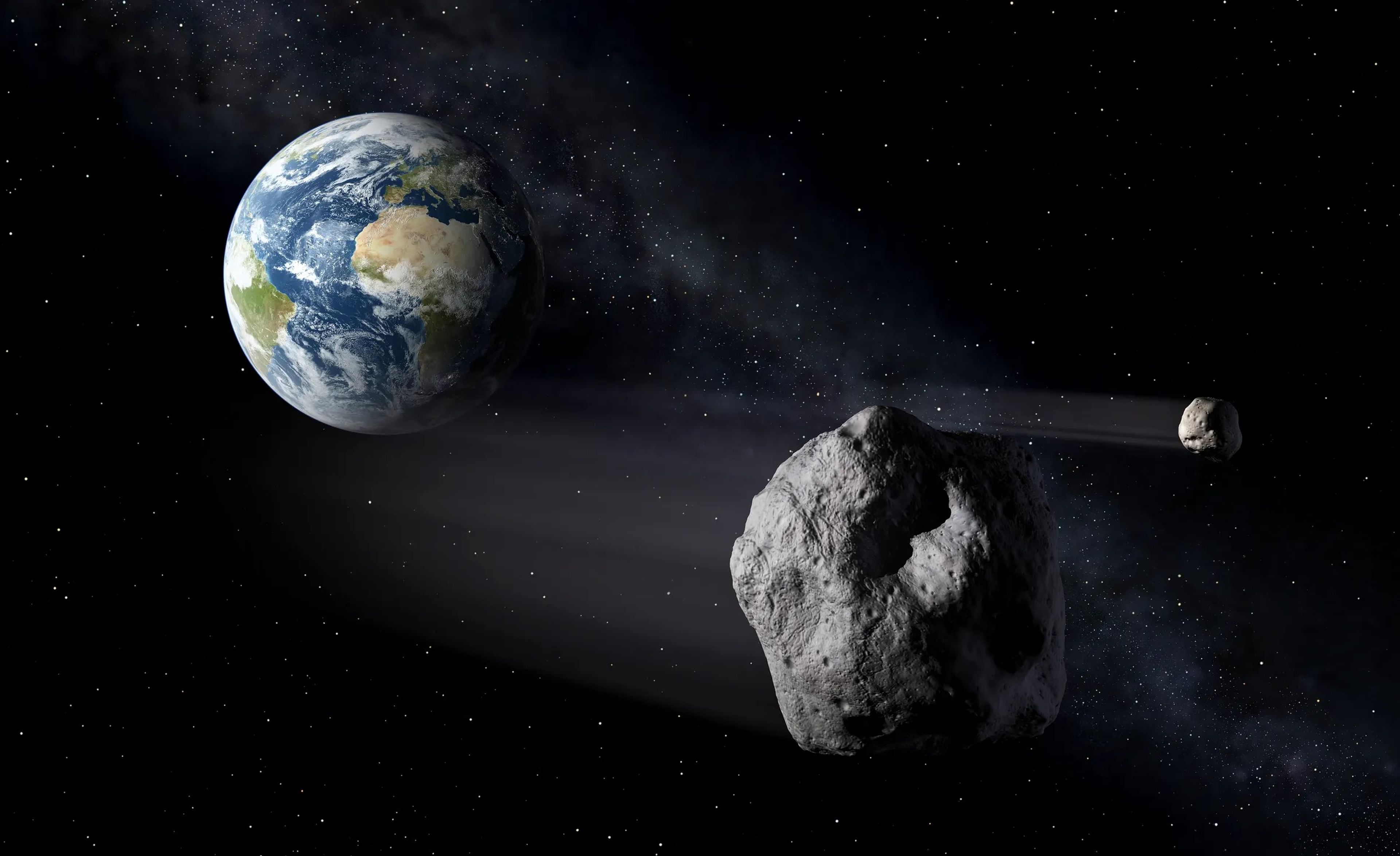 Ilustración artística de asteroides volando cerca de la Tierra.