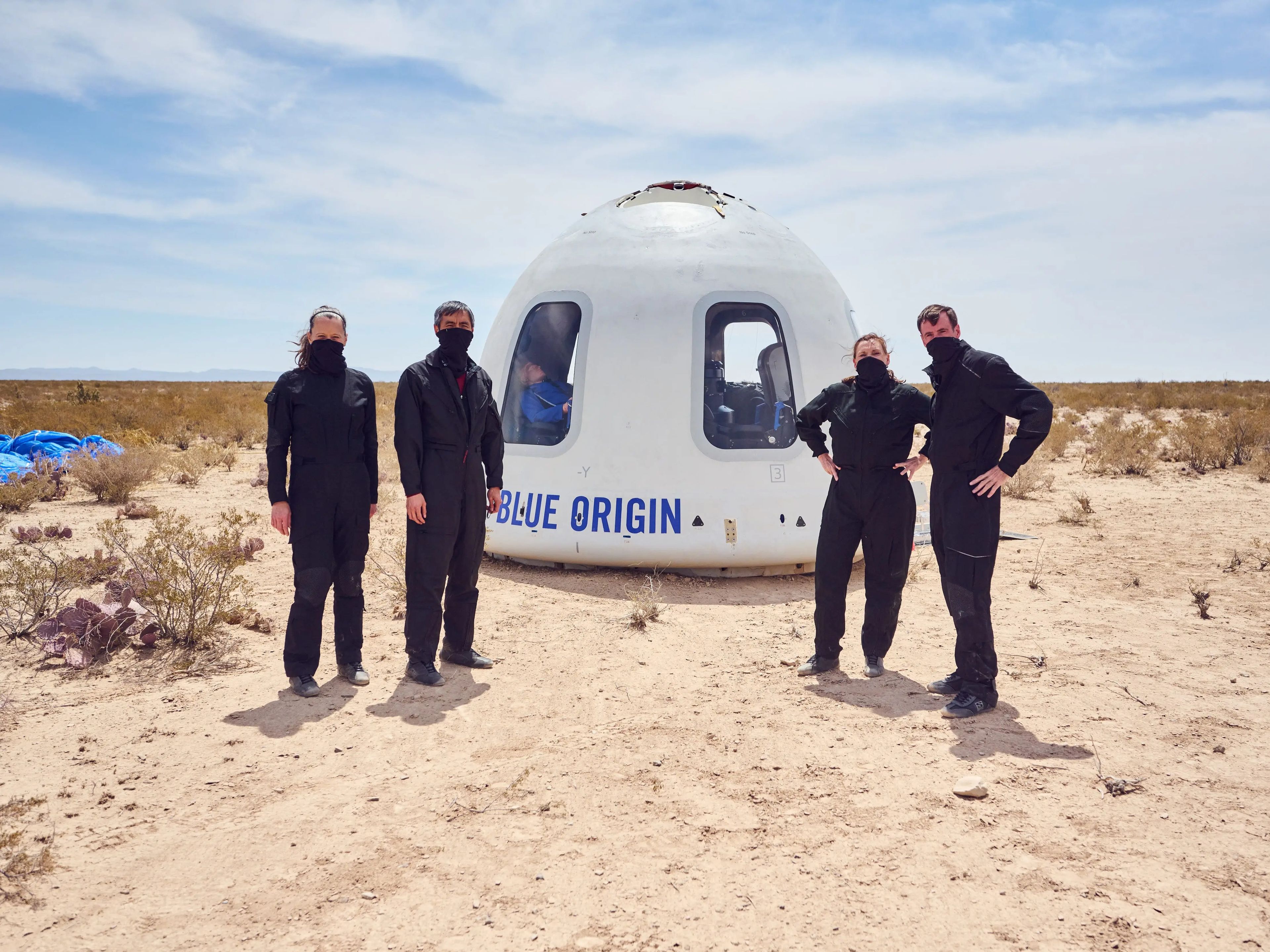 team stand in front of capsuleBlue Origin