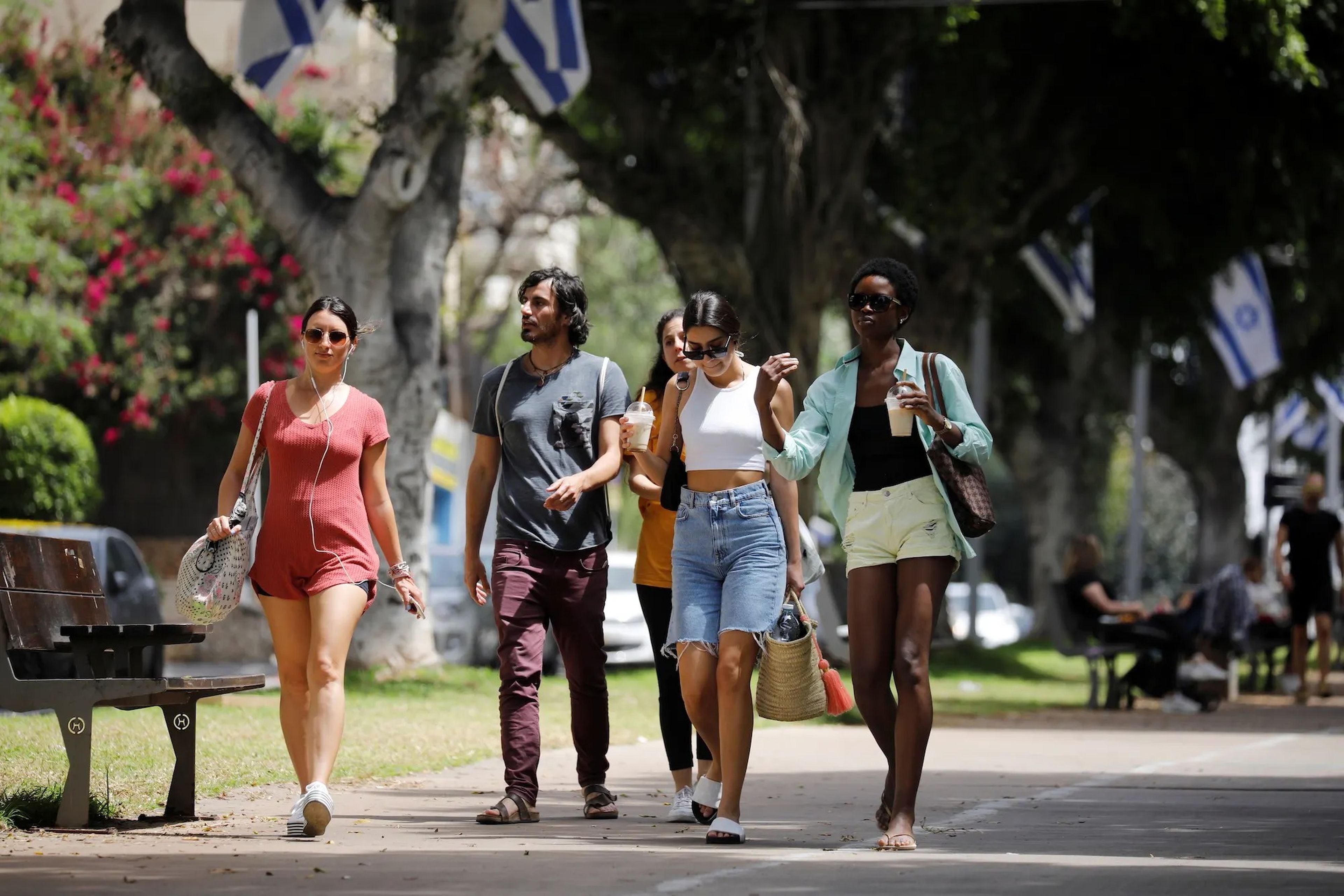 Pedestrians walk on a boulevard in Tel Aviv on April 18, 2021.