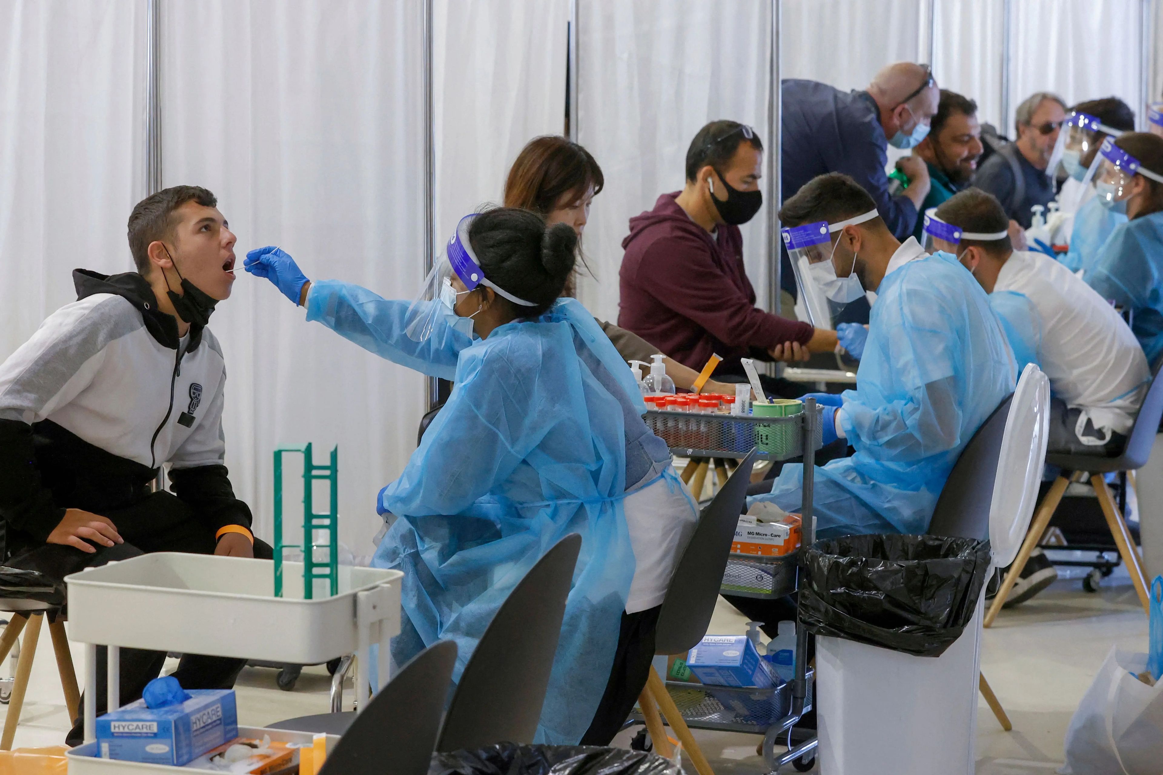 Israelis and vaccinated tourists get tested for COVID-19 upon arrival to Israel's Ben Gurion airport on May 23, 2021.