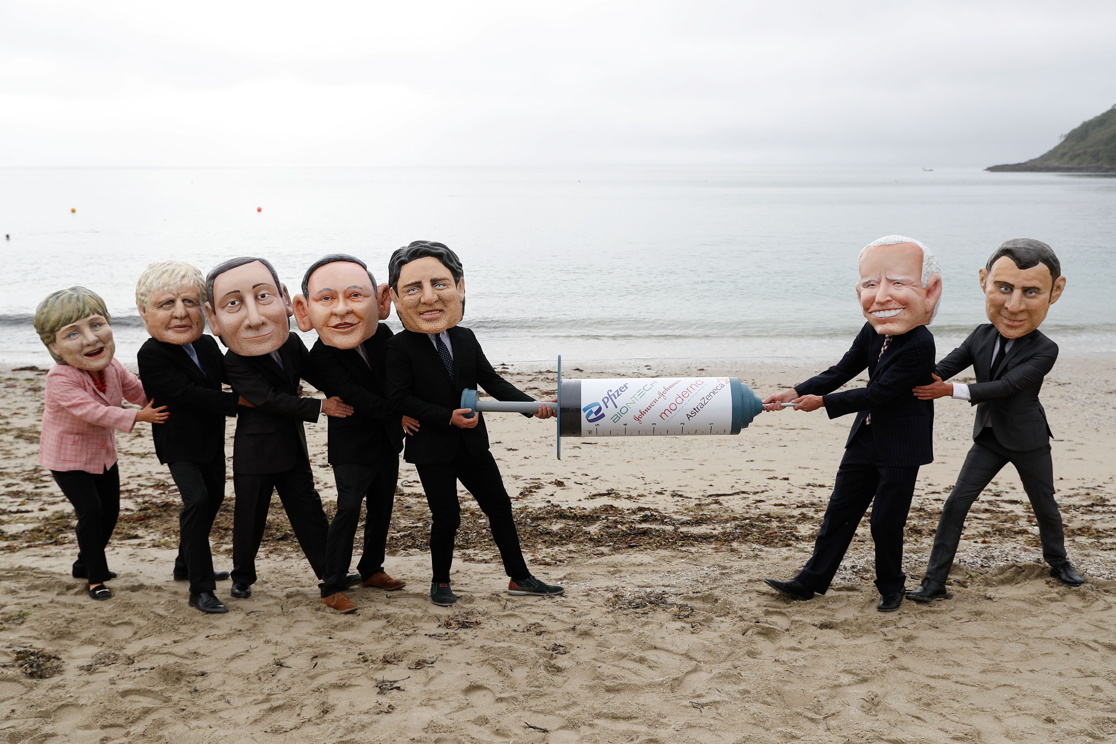 Activistas de Oxfam representan con caricaturas a los líderes del G7, simulando una lucha por las vacunas contra el coronavirus.