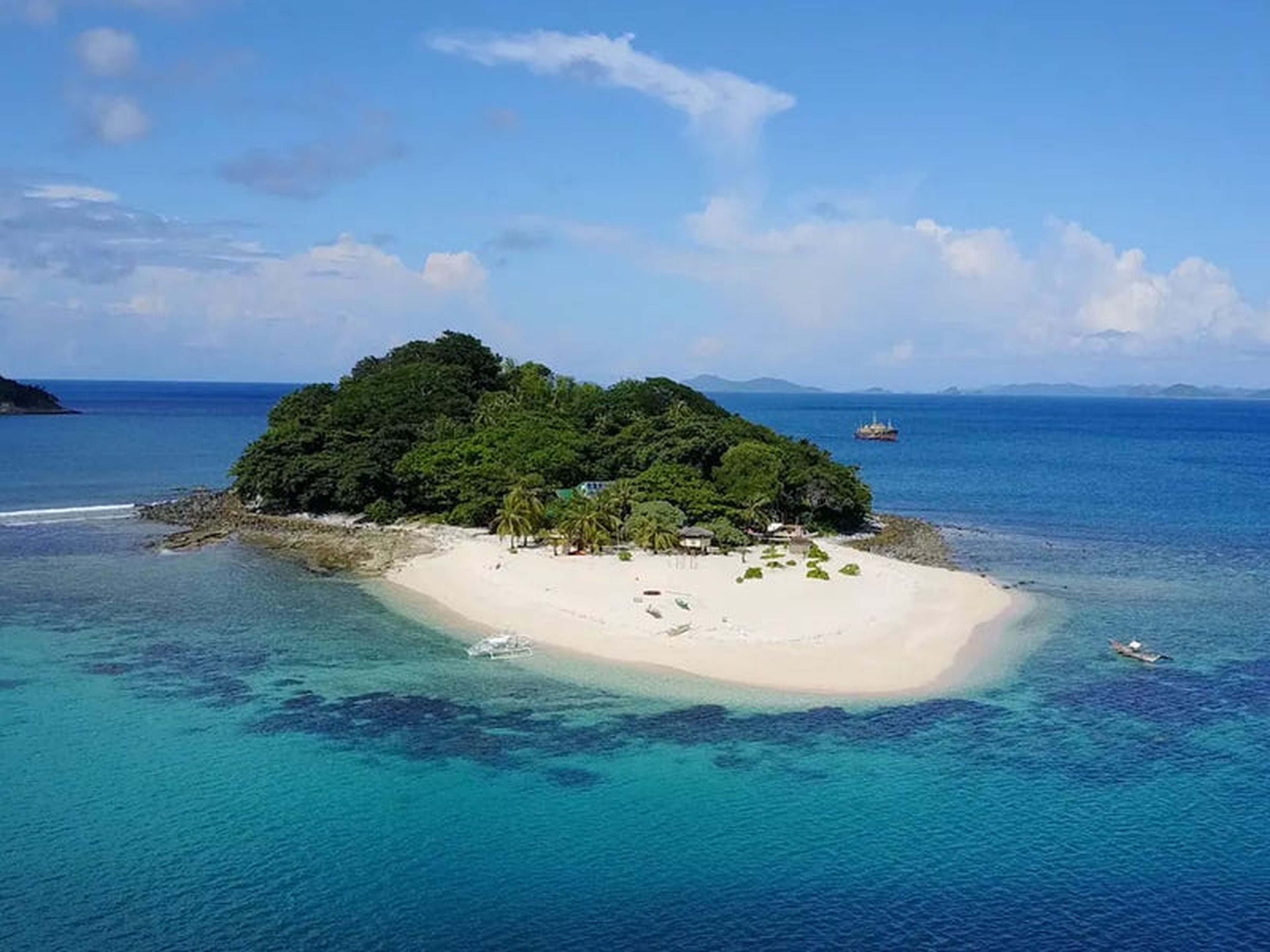 Una casa en una isla tropical con una playa de arena blanca en Filipinas