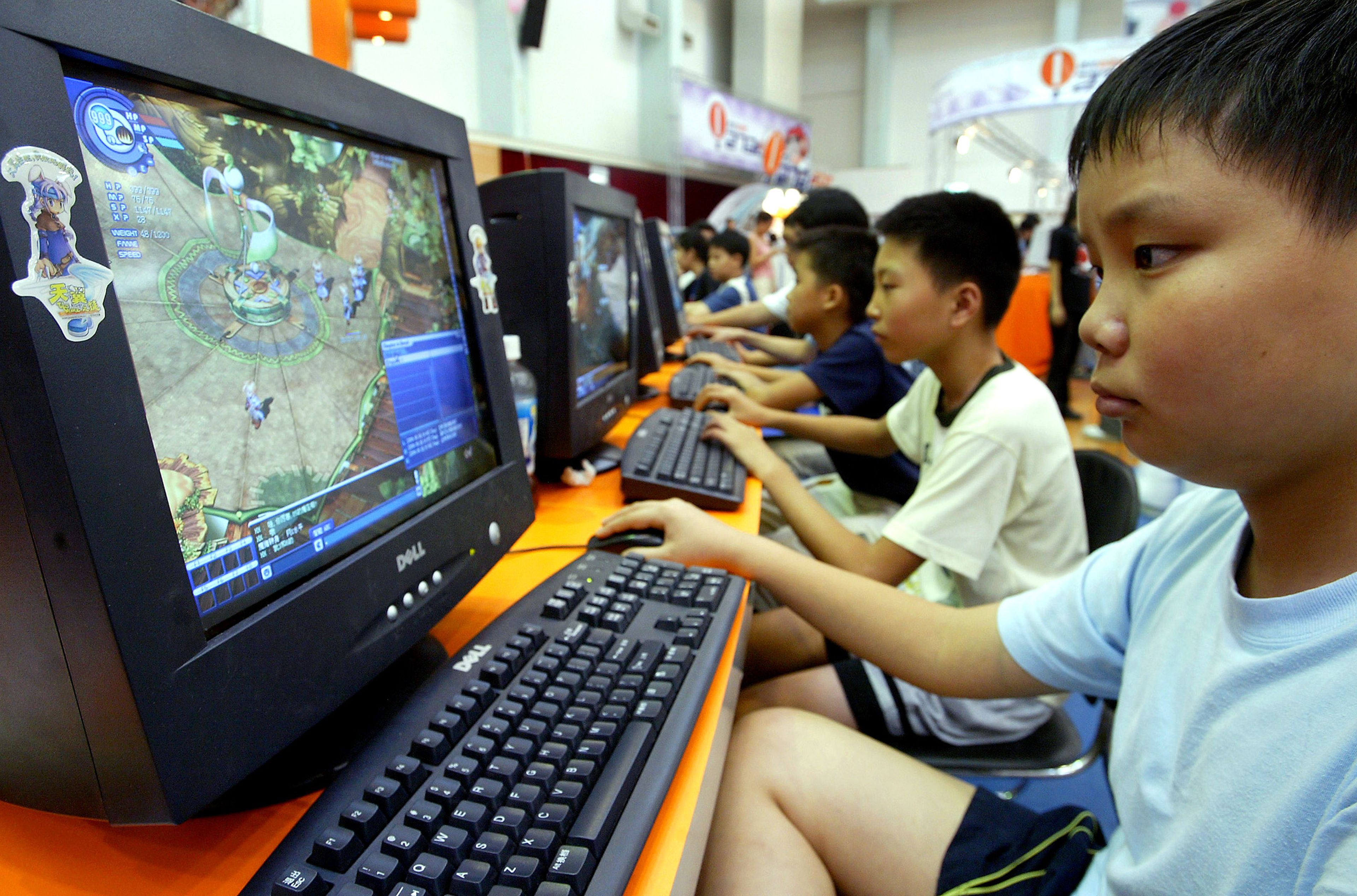 Un niño chino juega a un videojuego en el ordenador.