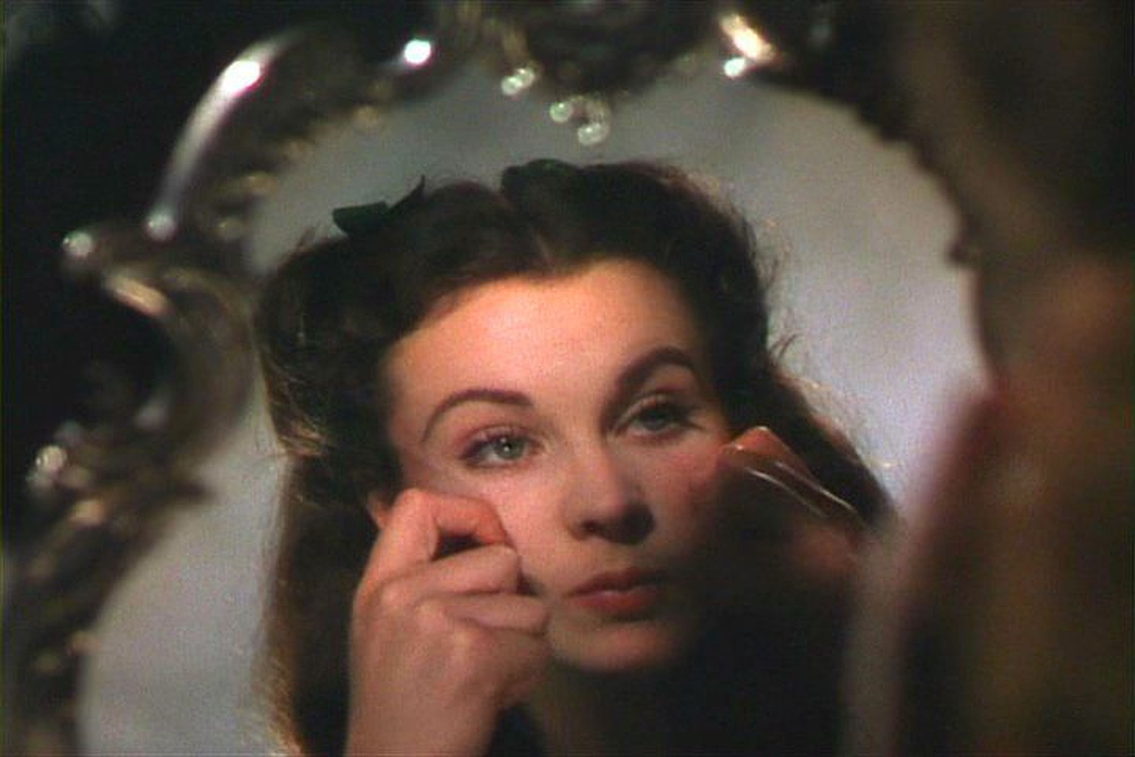 Scarlett O'Hara se pellizca sus mejillas para darles color en una escena de"Lo que el viento se llevó"(1939).