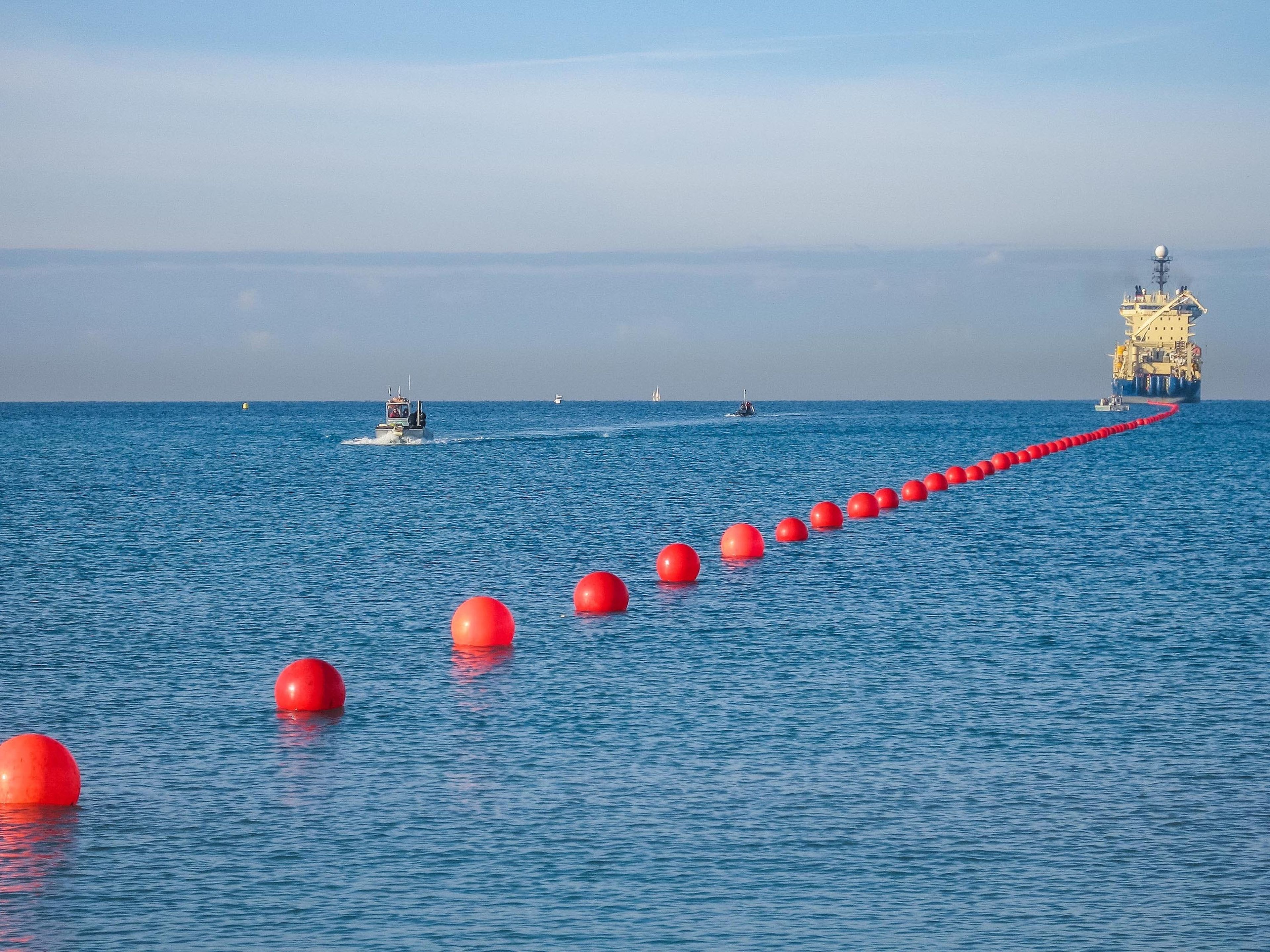 Una línea de boyas ayuda a hacer flotar un cable de Internet submarino cuando aterriza en la orilla. Alcatel