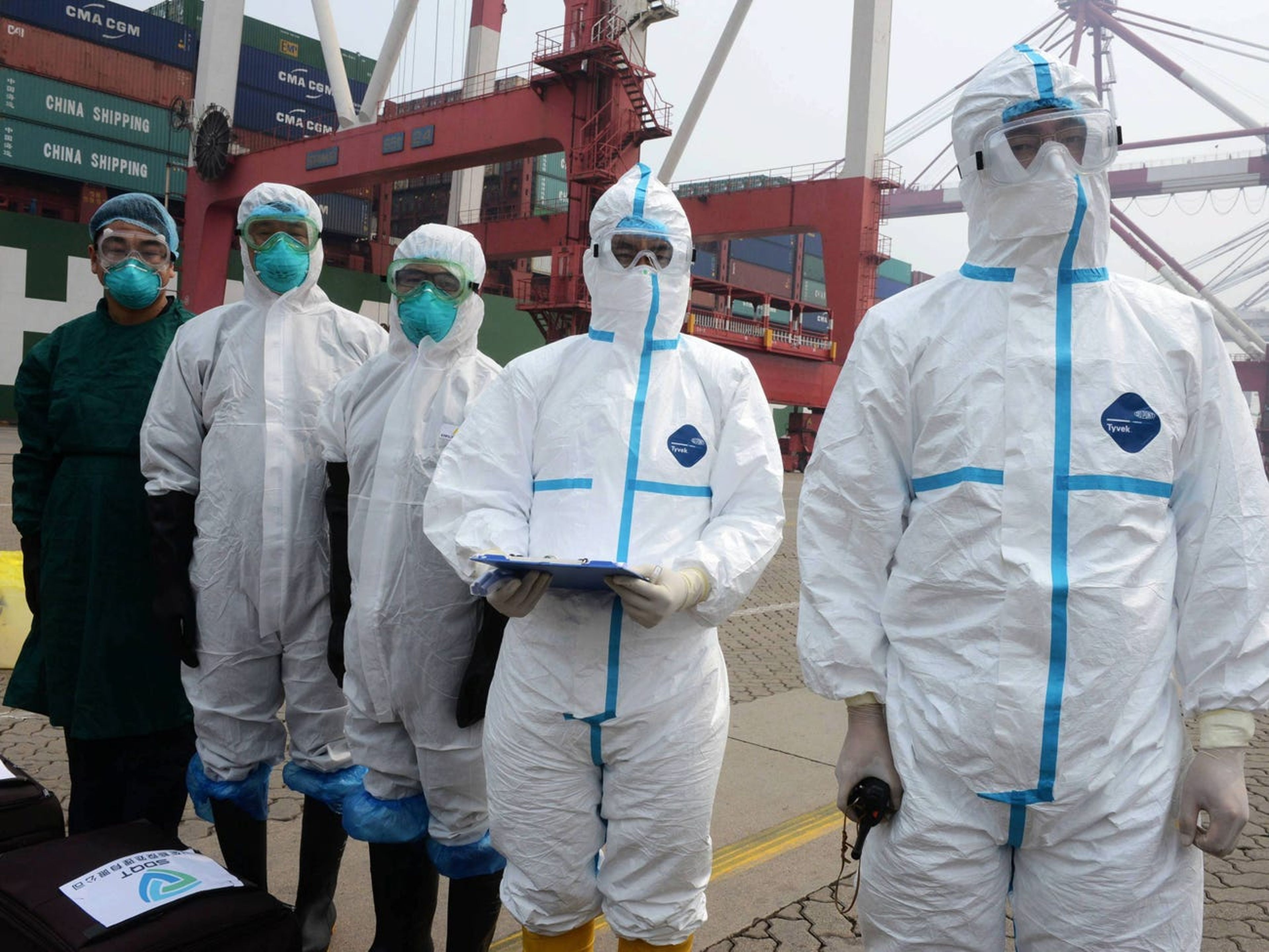 Investigadores lidian con un supuesto paciente del Síndrome Respiratorio de Oriente Medio (MERS) en un puerto marítimo el 18 de junio de 2015 en Qingdao, China.
