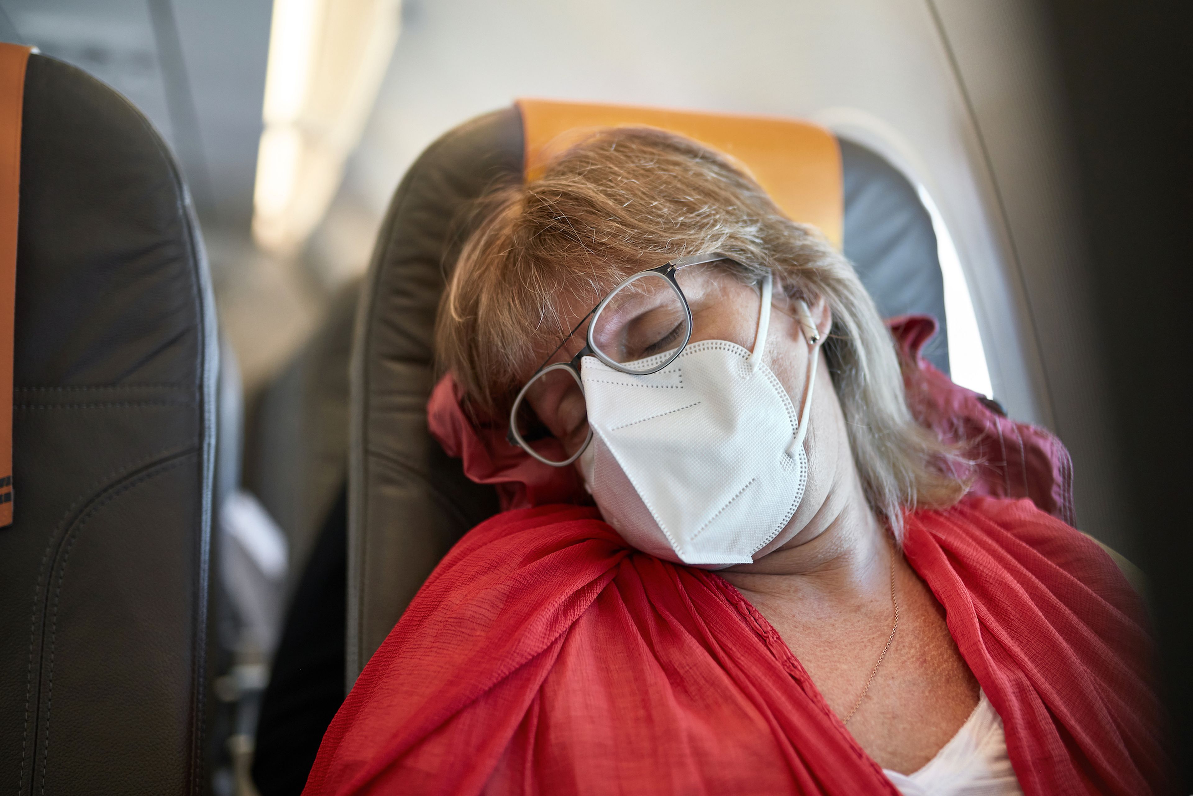 Mujer durmiendo en avión