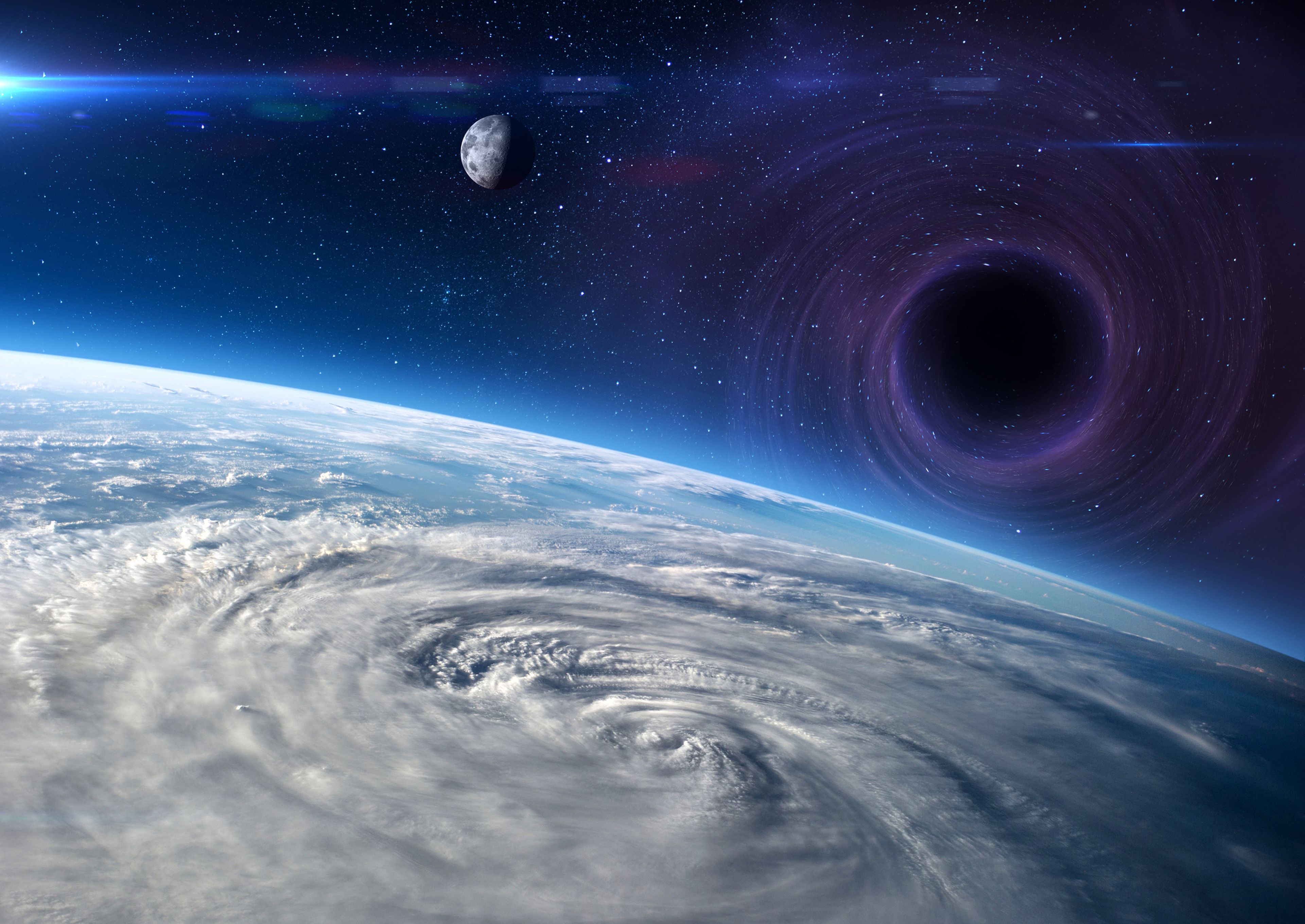 Montaje con un agujero negro, el planeta Tierra y la Luna, extraído de imágenes de la NASA.