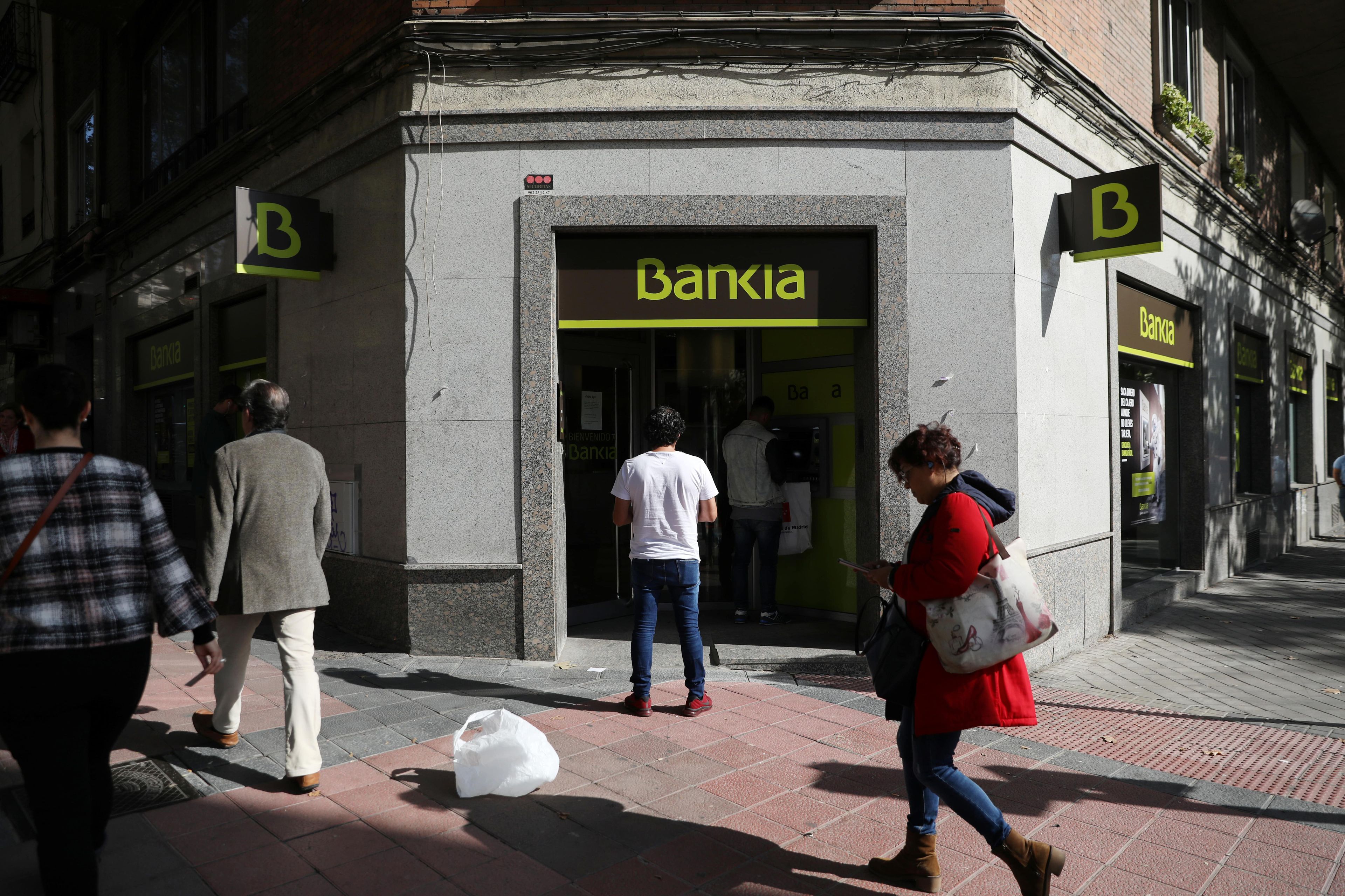 Clientes de Bankia haciendo cola en un cajero