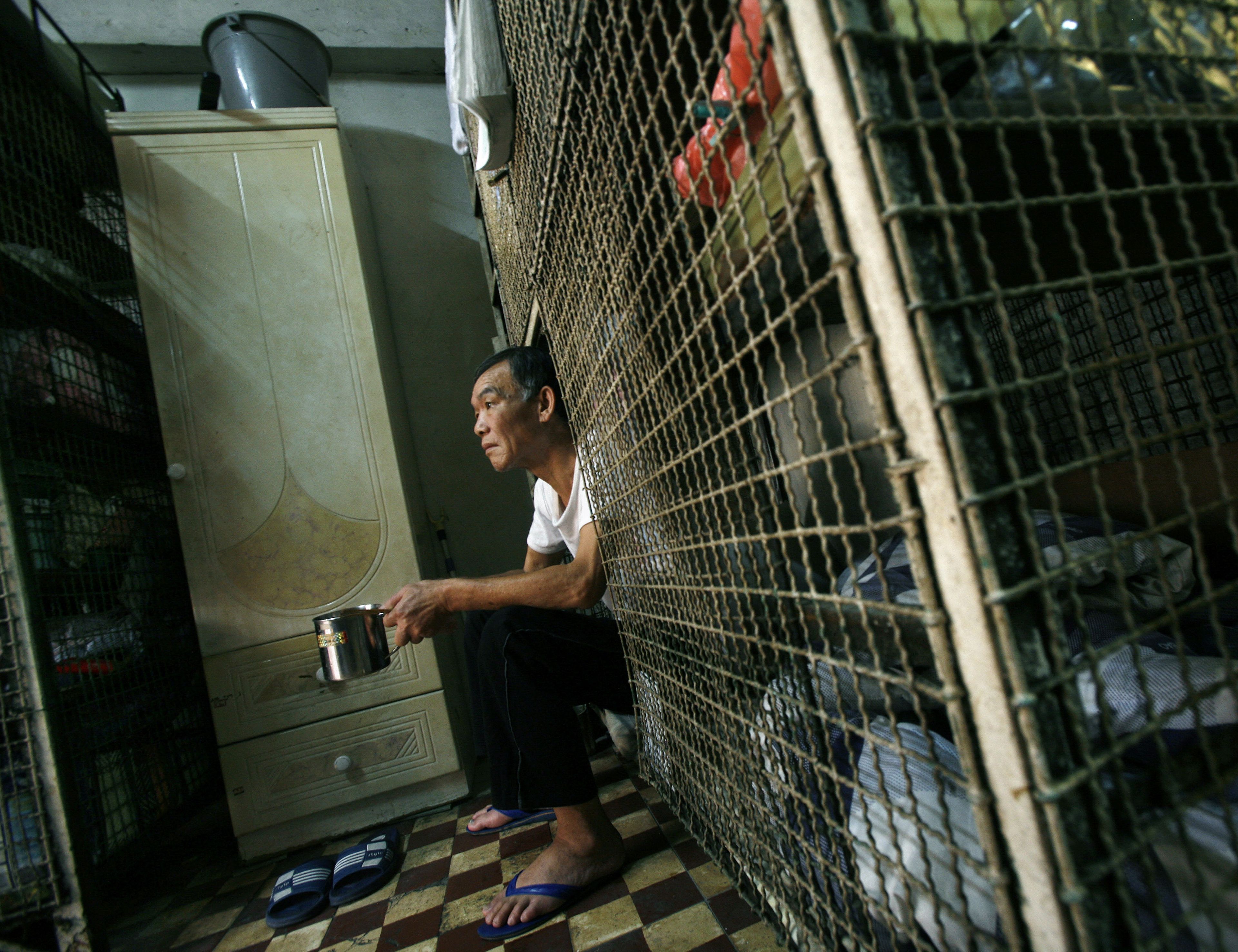 Kong Siu-kau, de 63 años, sentado en su cama jaula en Hong Kong en 2009.
