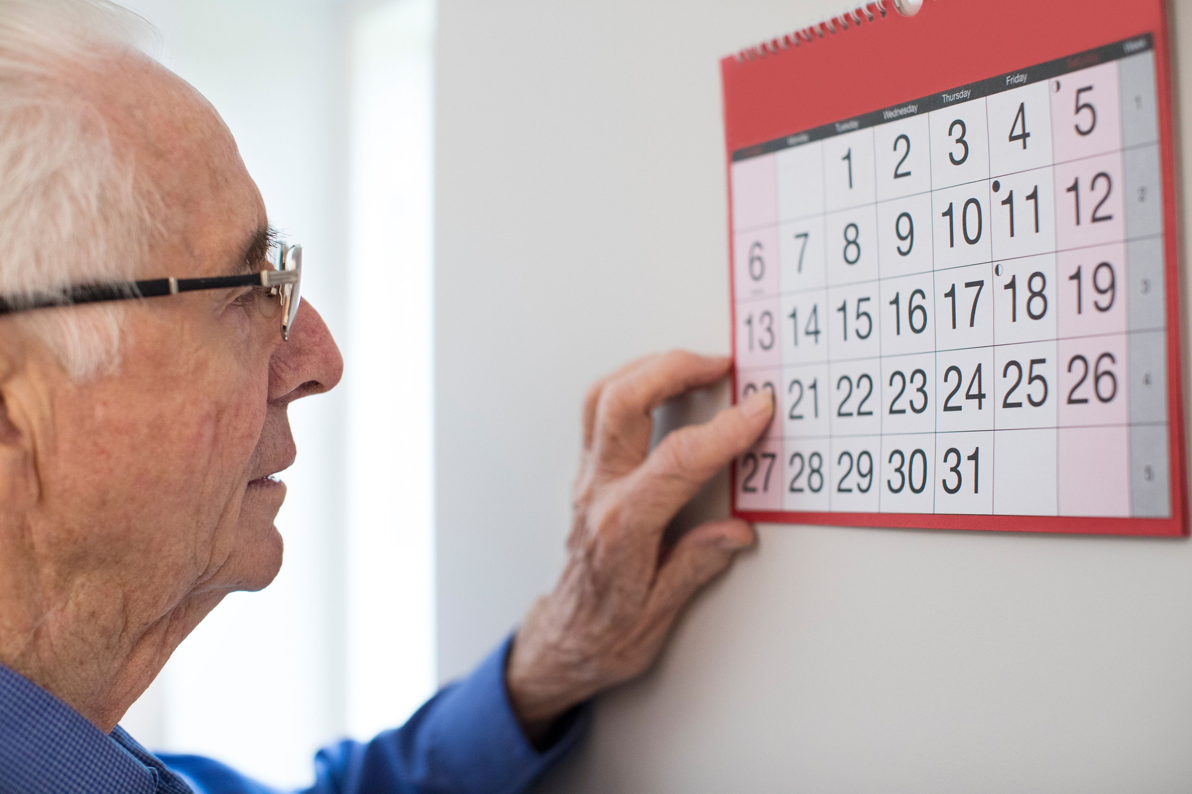 Hombre mayor jubilado mira un calendario