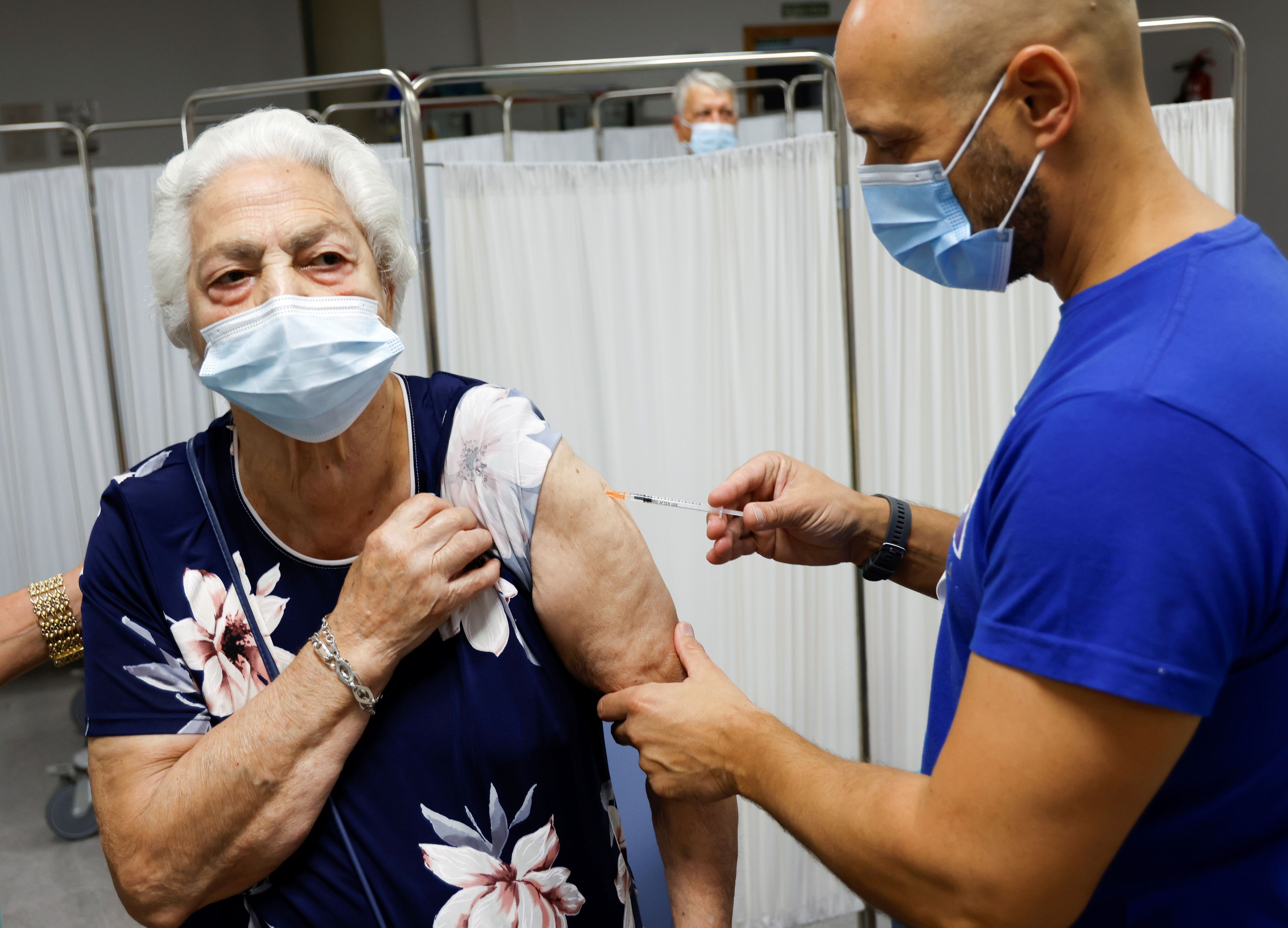 Señora recibe una vacuna de refuerzo contra COVID-19 en España