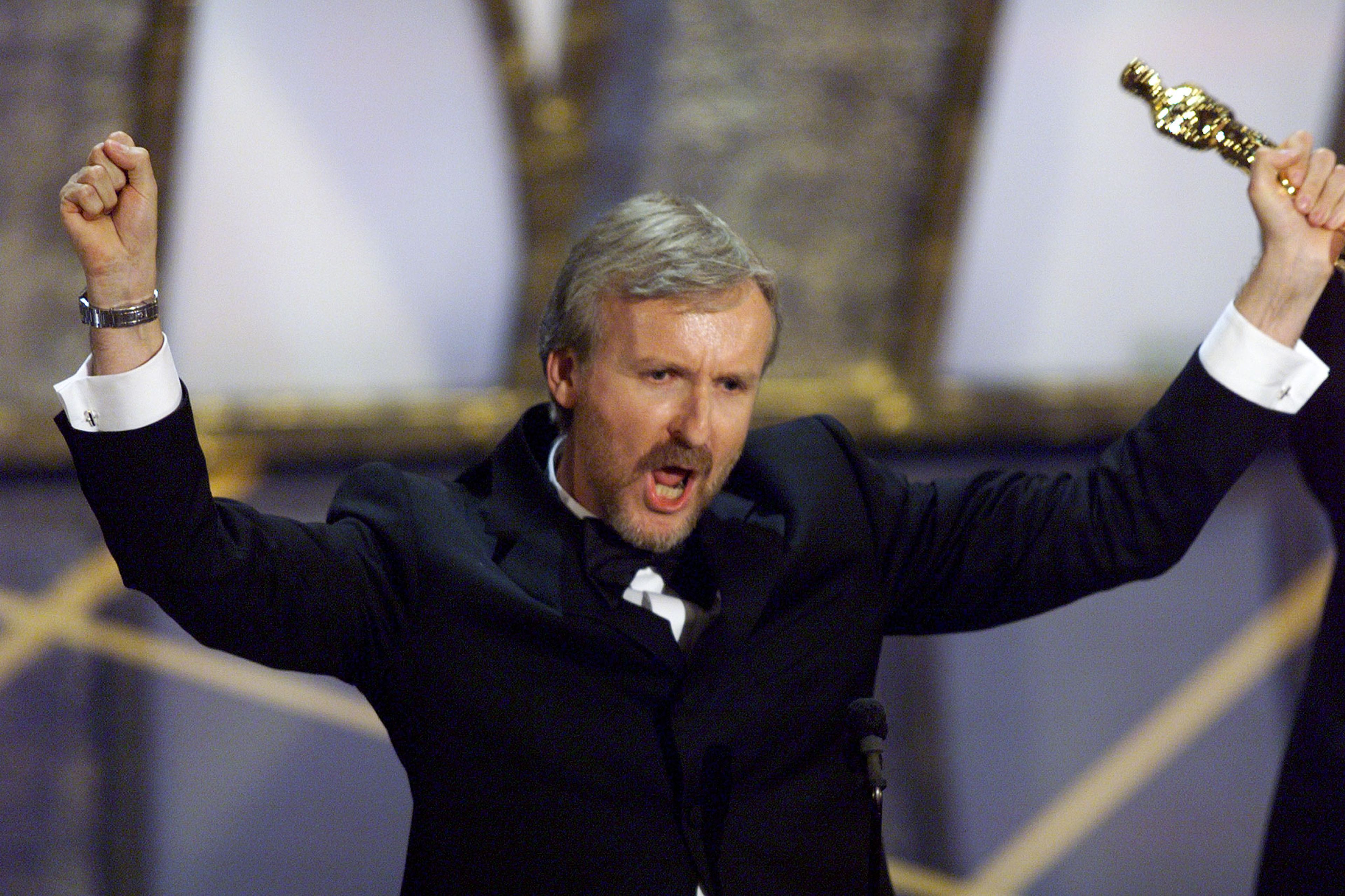 James Cameron celebrating his Oscar for Best Director for 'Titanic'.