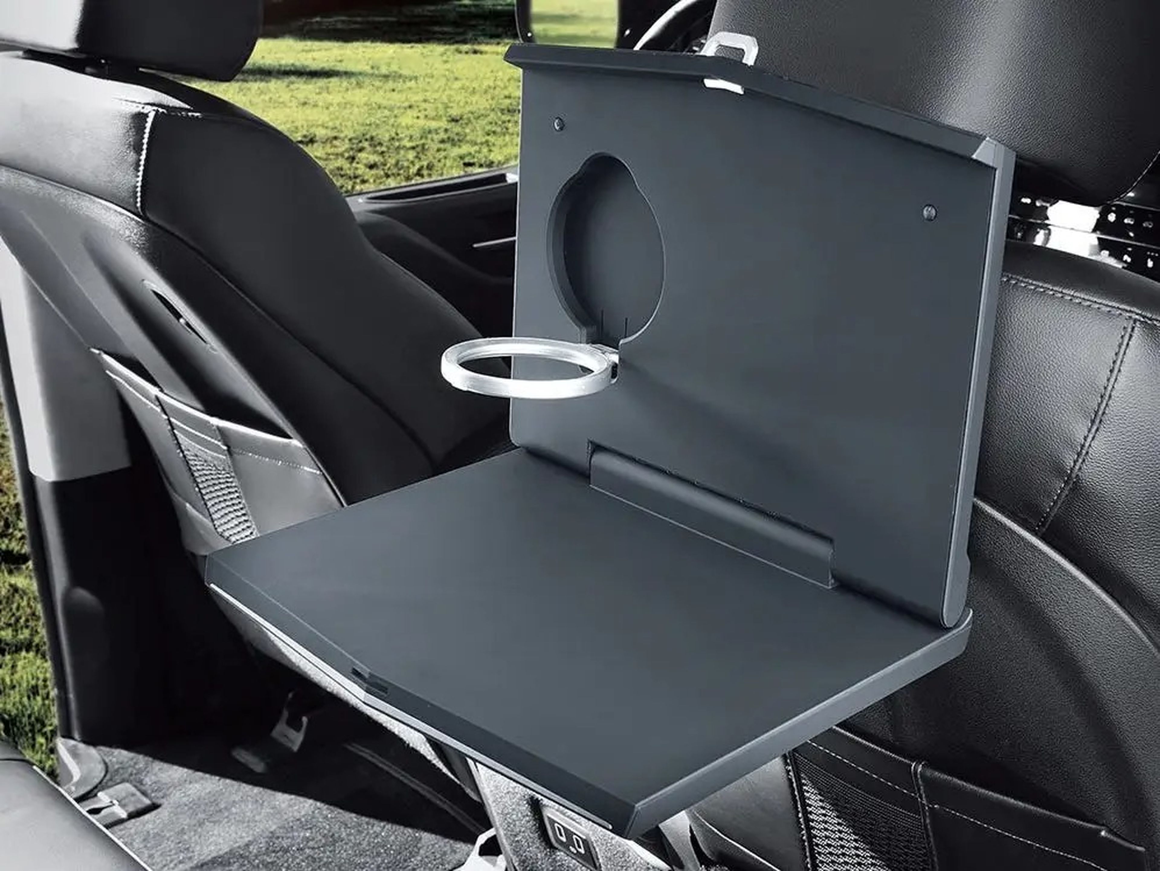 The Hyundai Staria Lounge Camper's interior table in front of a seat.