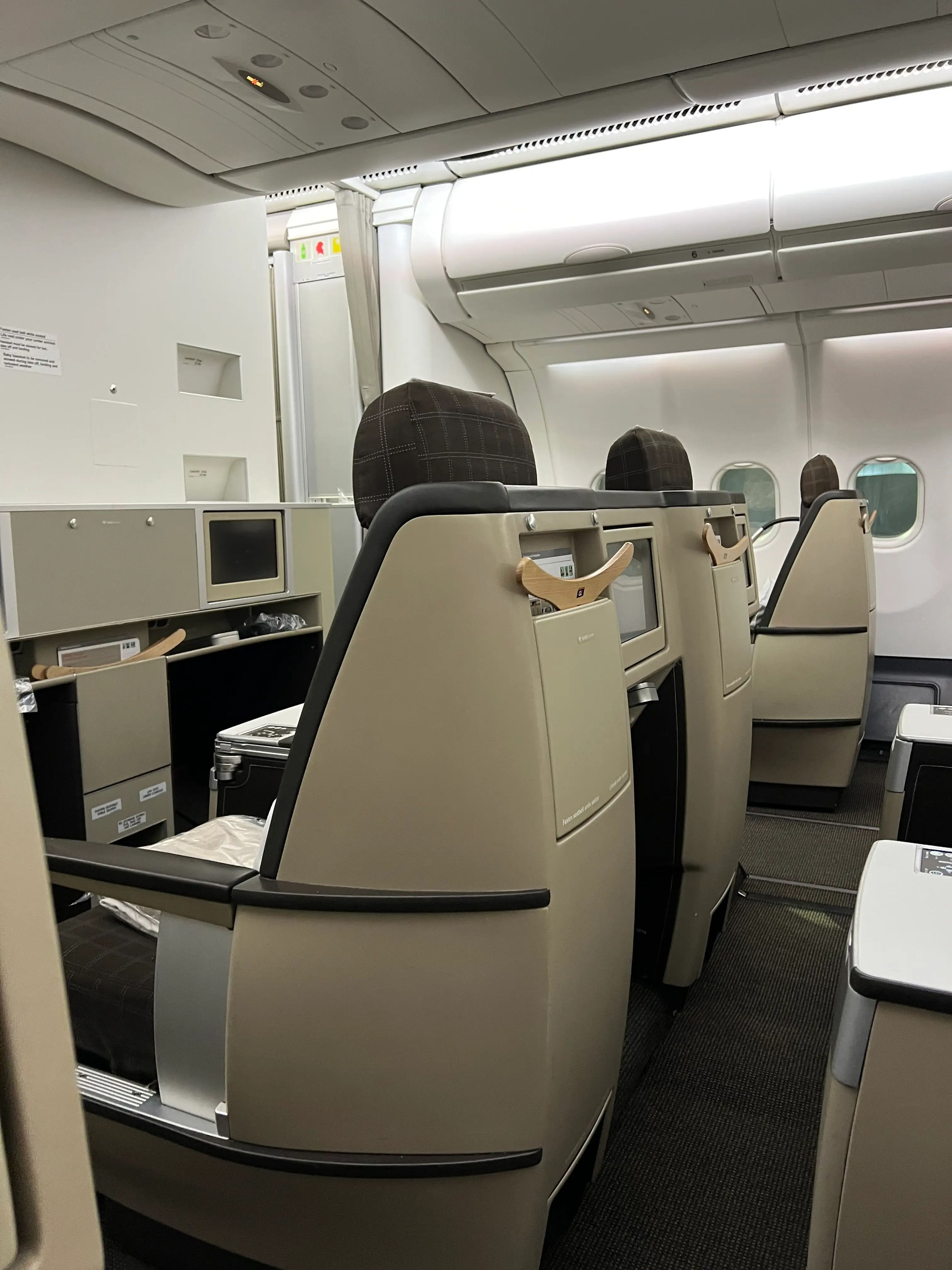 a phot of the rows of business-class seats on a plane