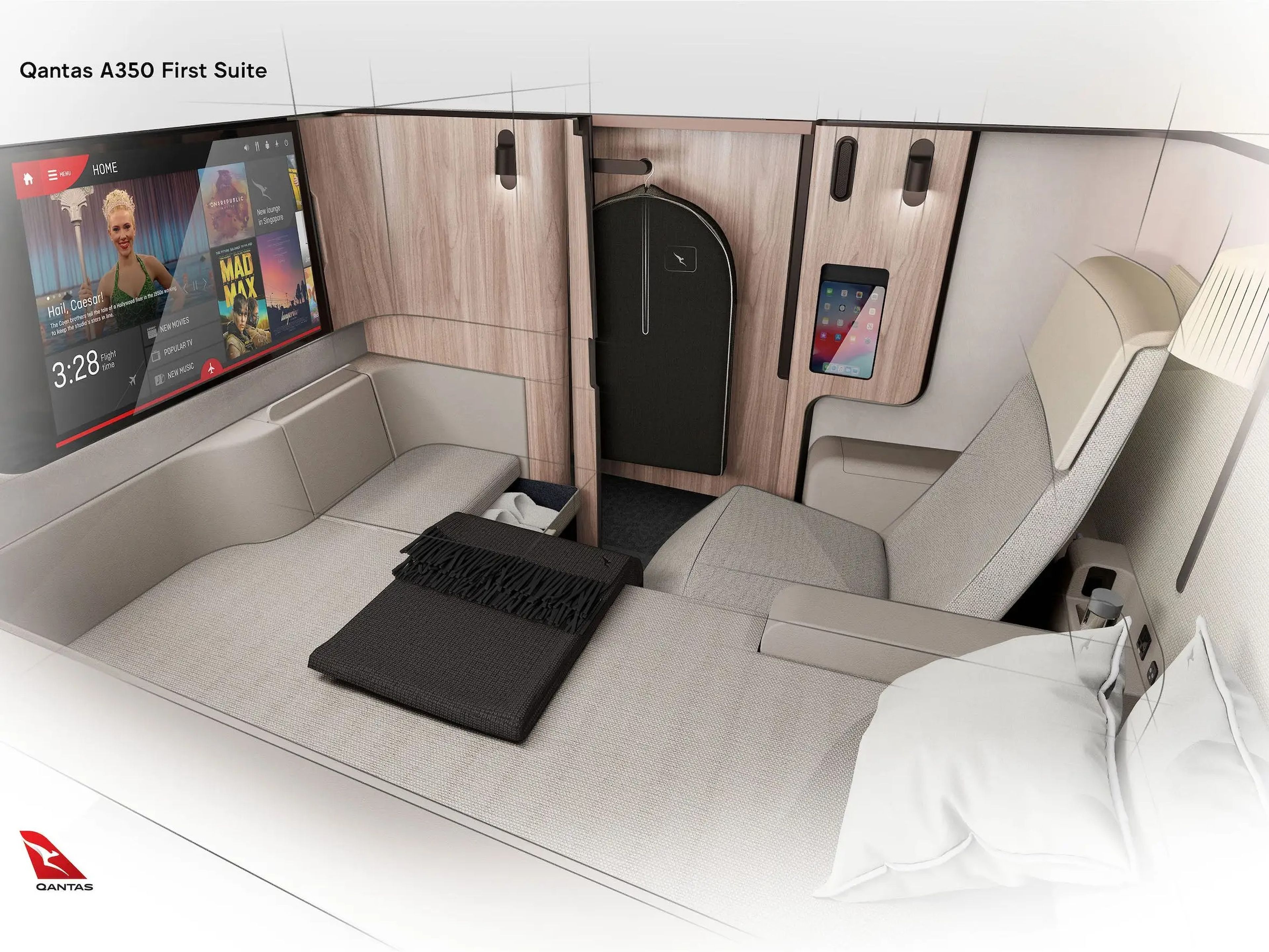 The Qantas A350 first suite has a bed, seating area that both face a television.