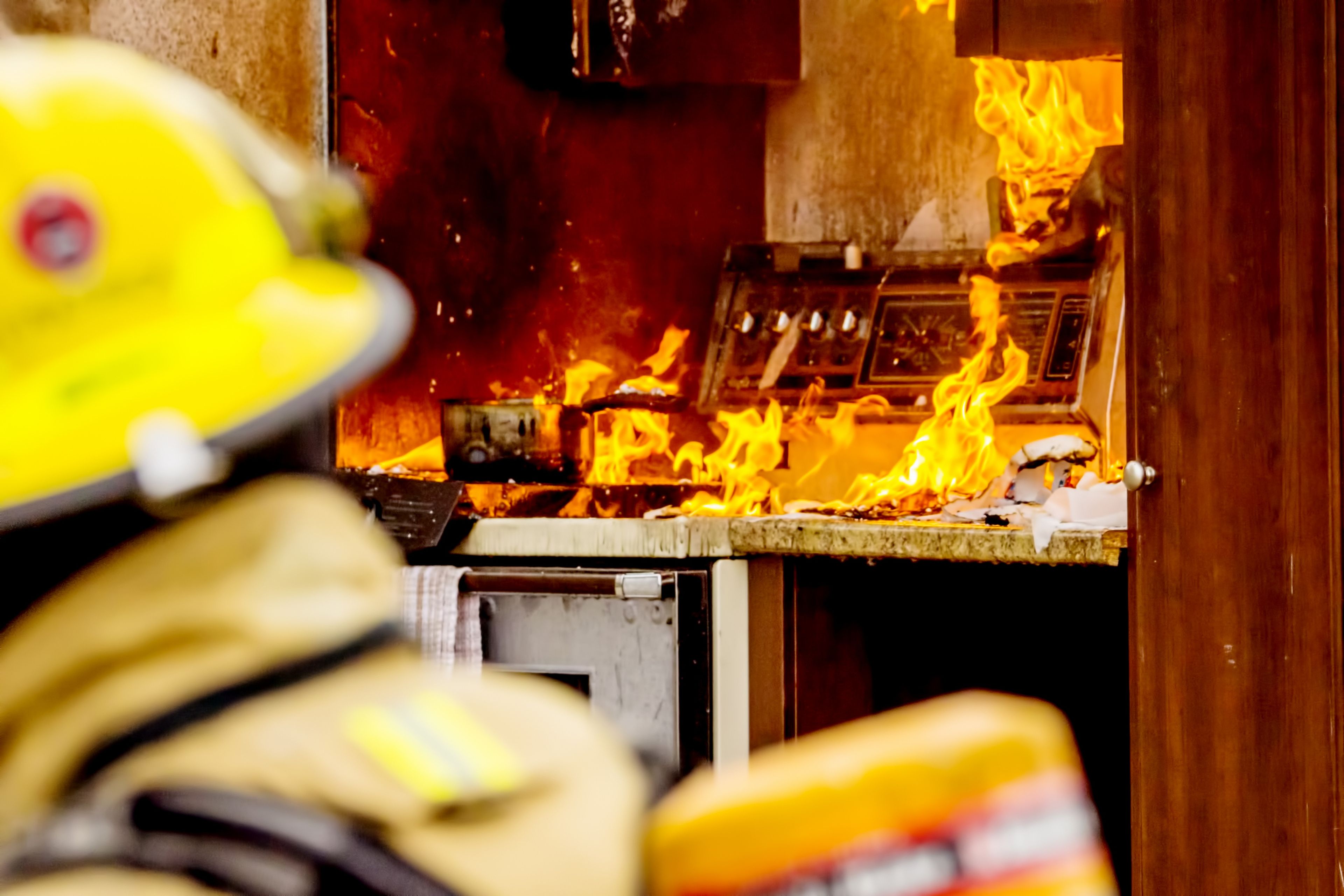 Un bombero, frente a un incendio en la cocina de una casa