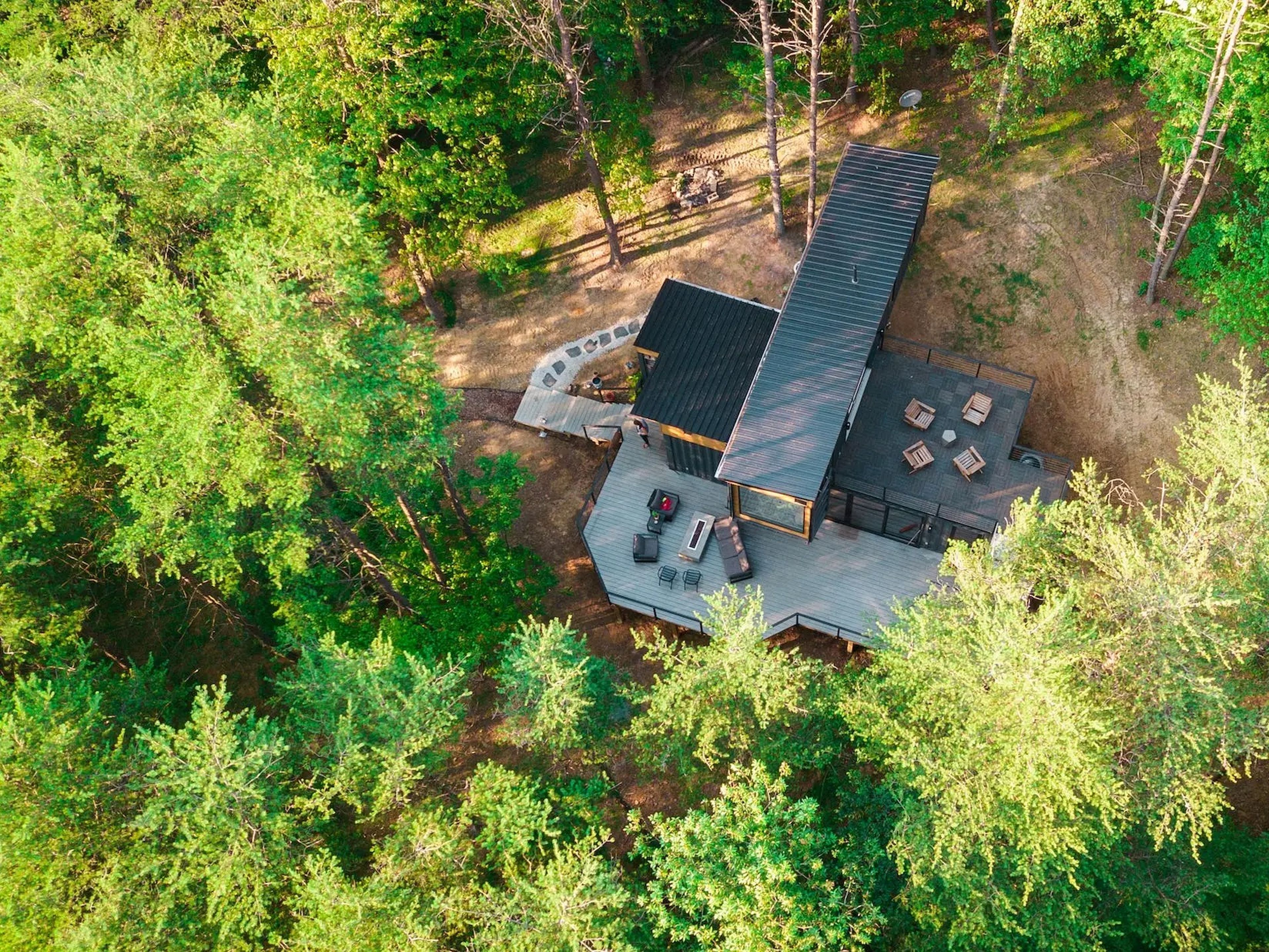 The OG shipping container home by the Box Hop surrounded by trees
