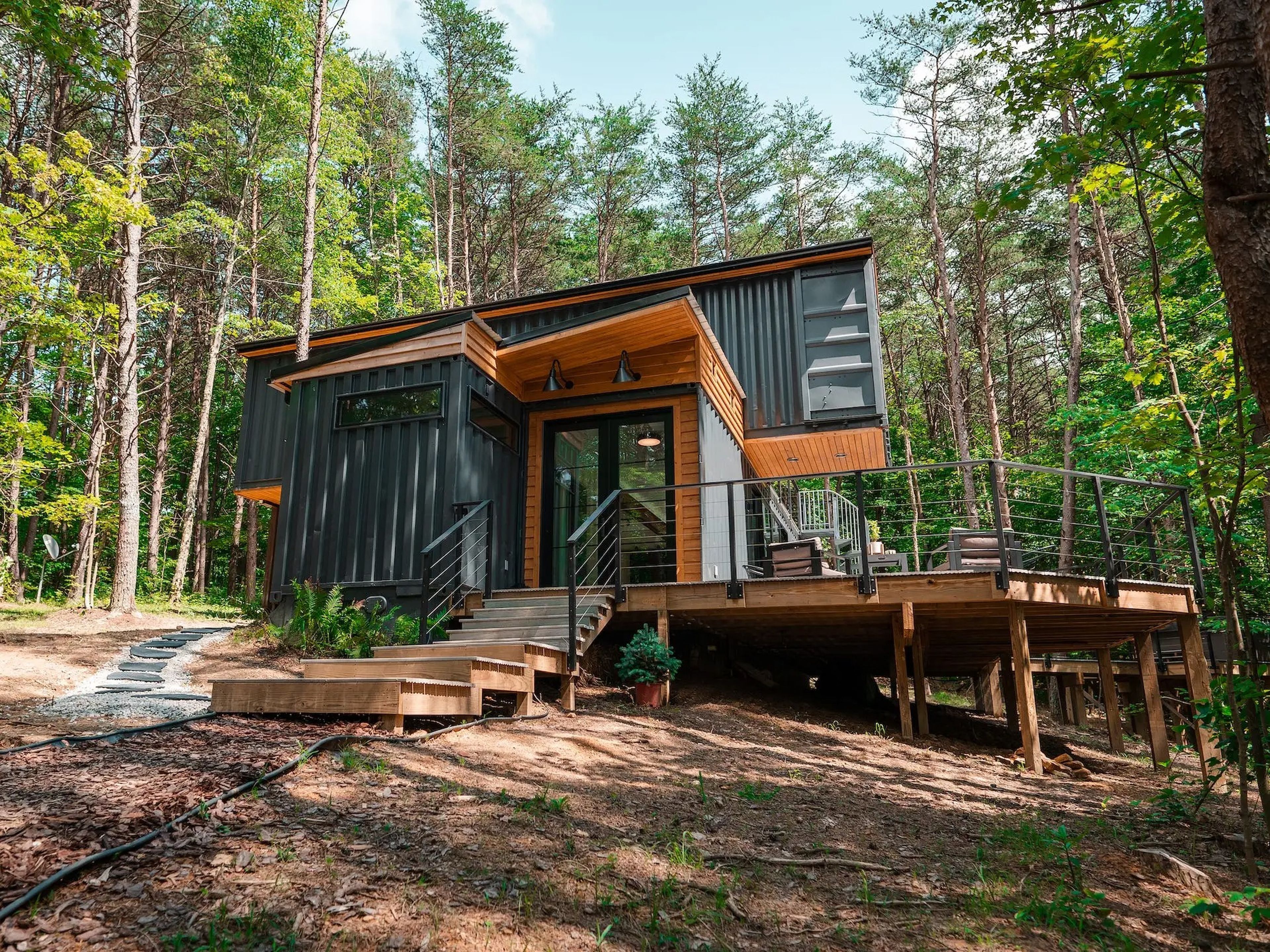 The OG shipping container home by the Box Hop surrounded by trees