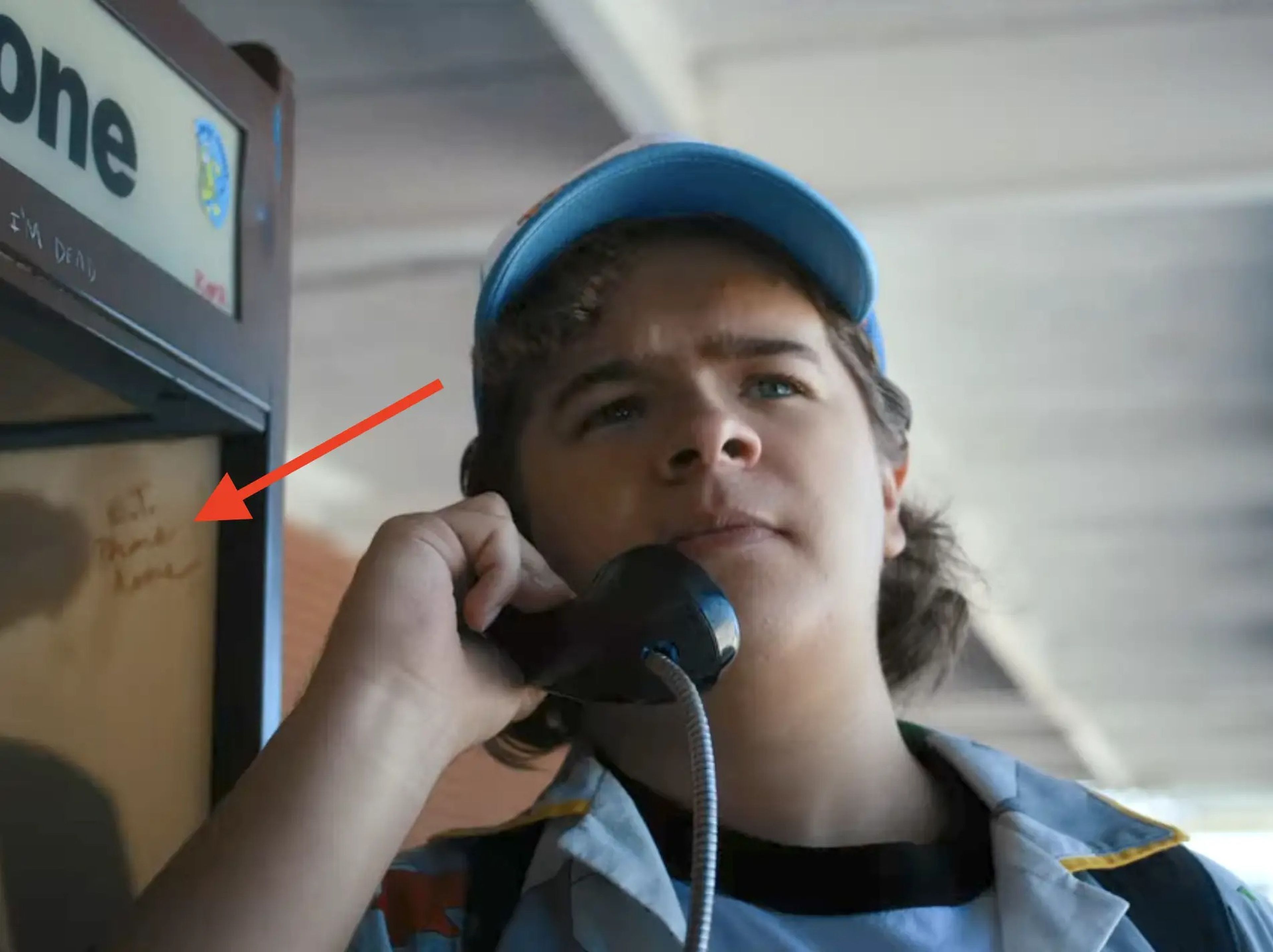 A scene from Netflix's sci-fi series "Stranger Things," showing Dustin on the payphone.