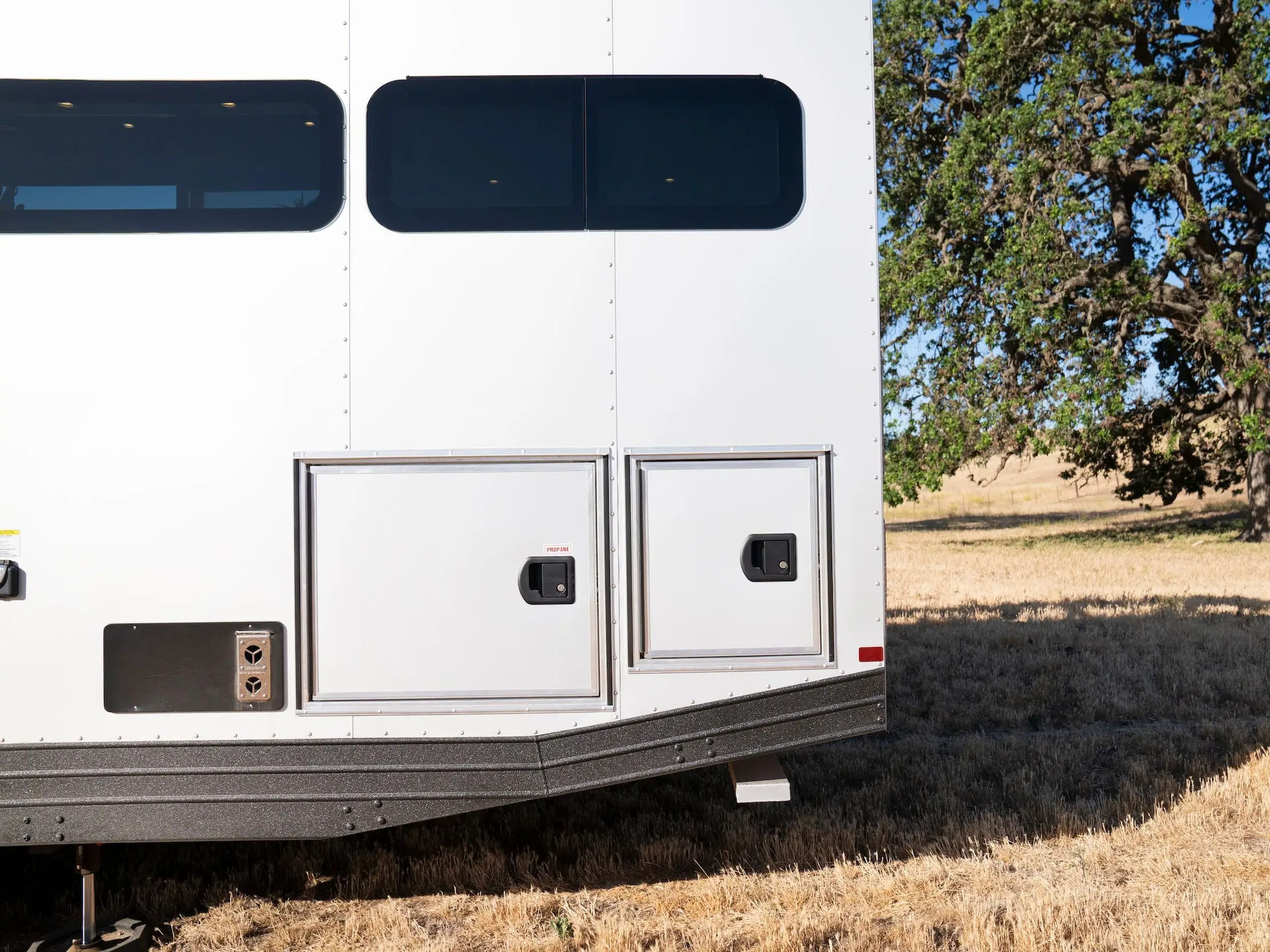 A close up of the exterior of the travel trailer with storage units.