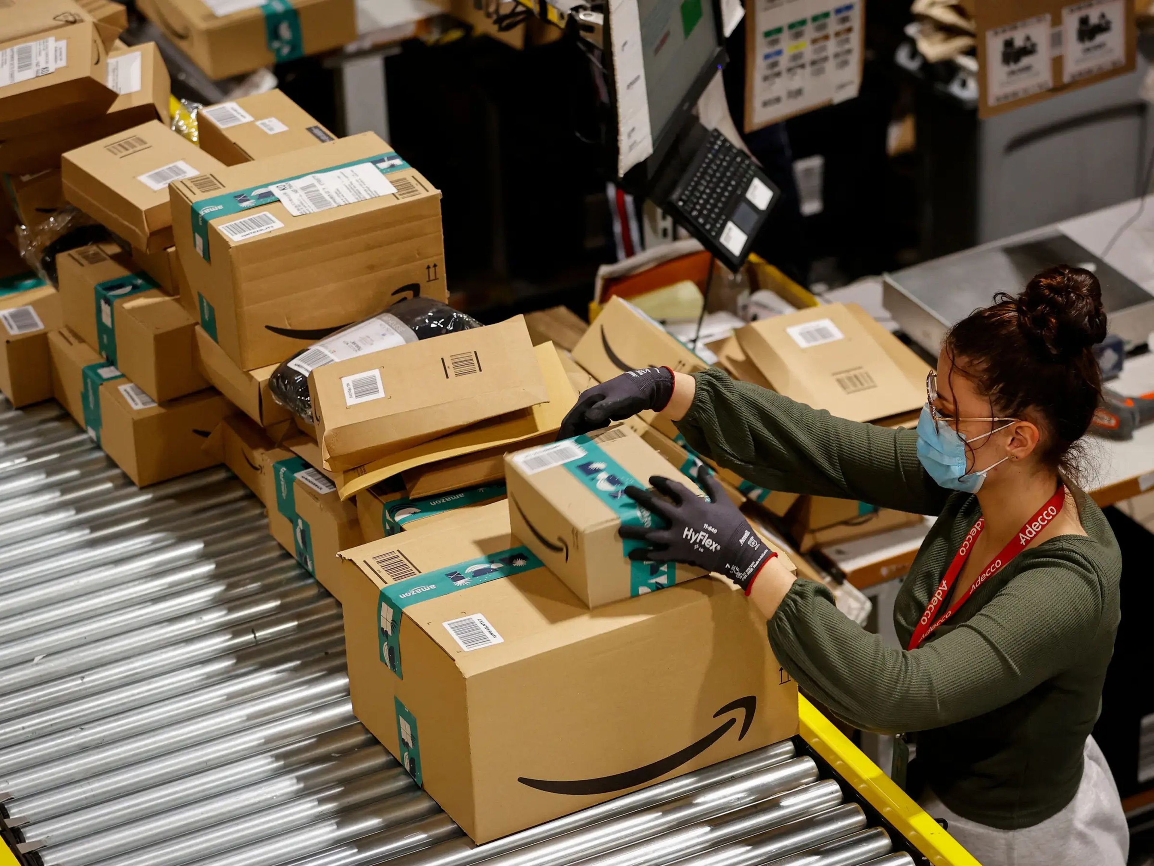 AnAn employee handles packages at the Amazon's Bretigny-sur-Orge warehouse in France.