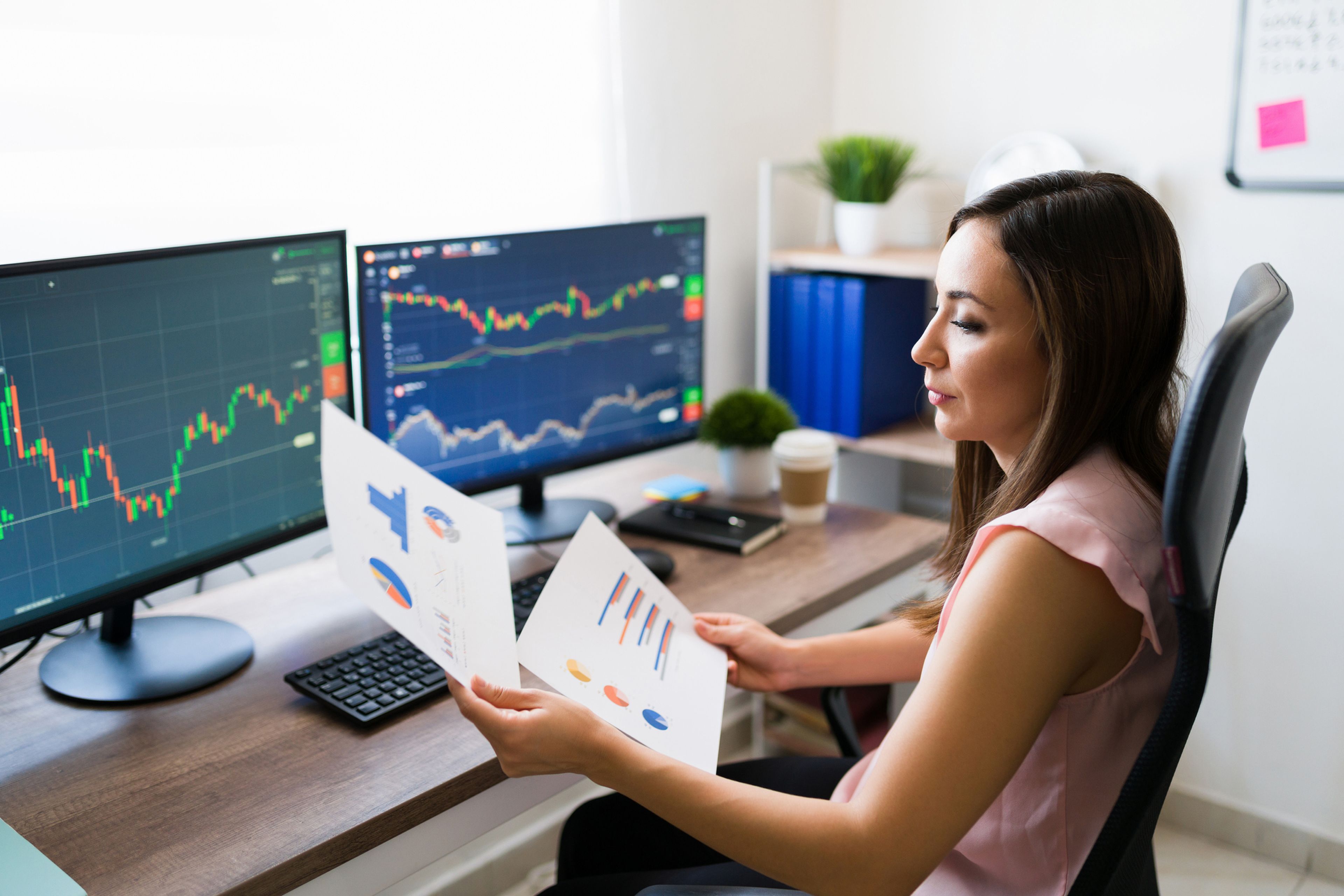 Woman Looking At Graph Of Her Investment In Stock Market