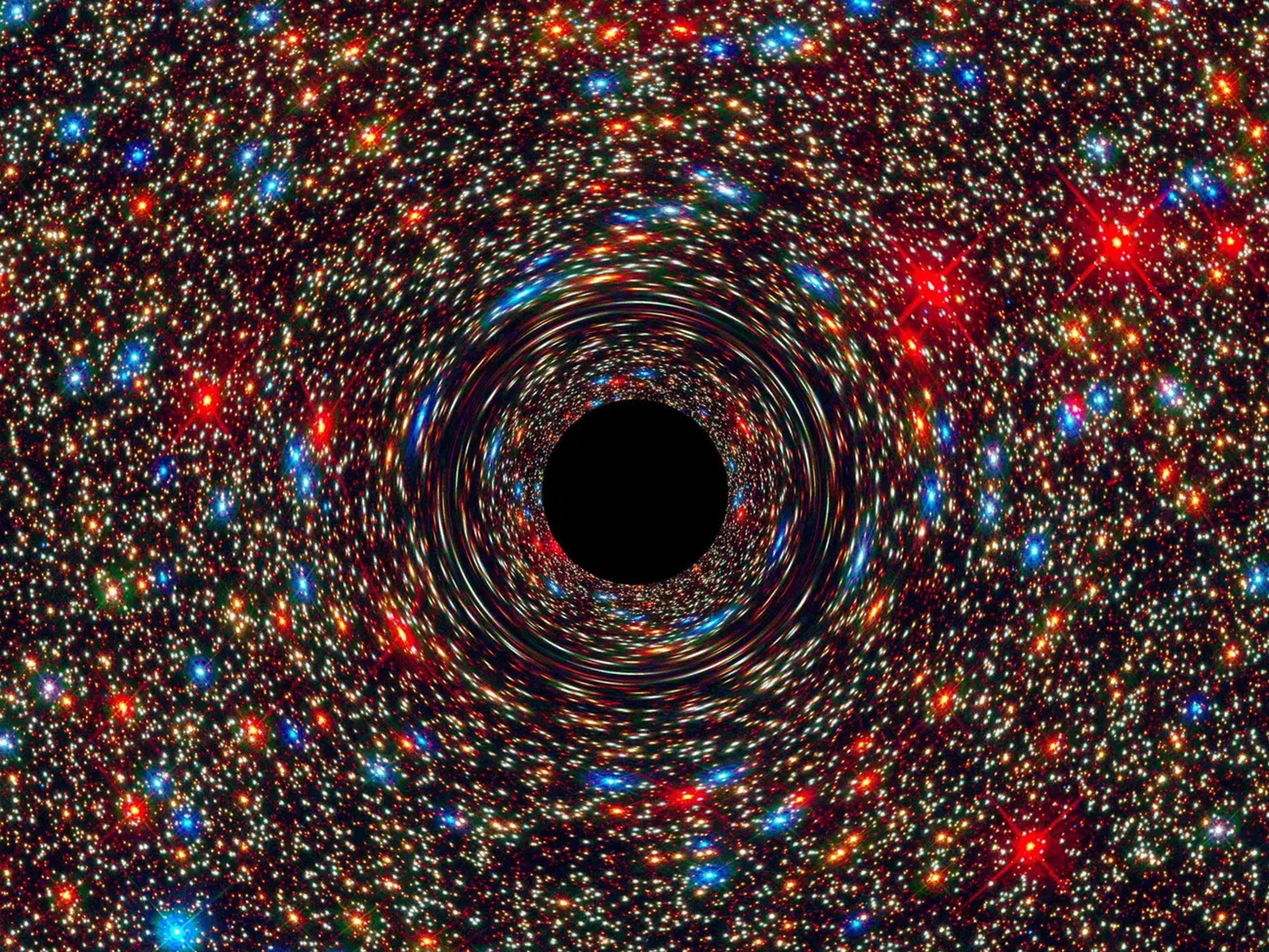 Esta imagen simulada muestra un agujero negro supermasivo en el centro de una galaxia.