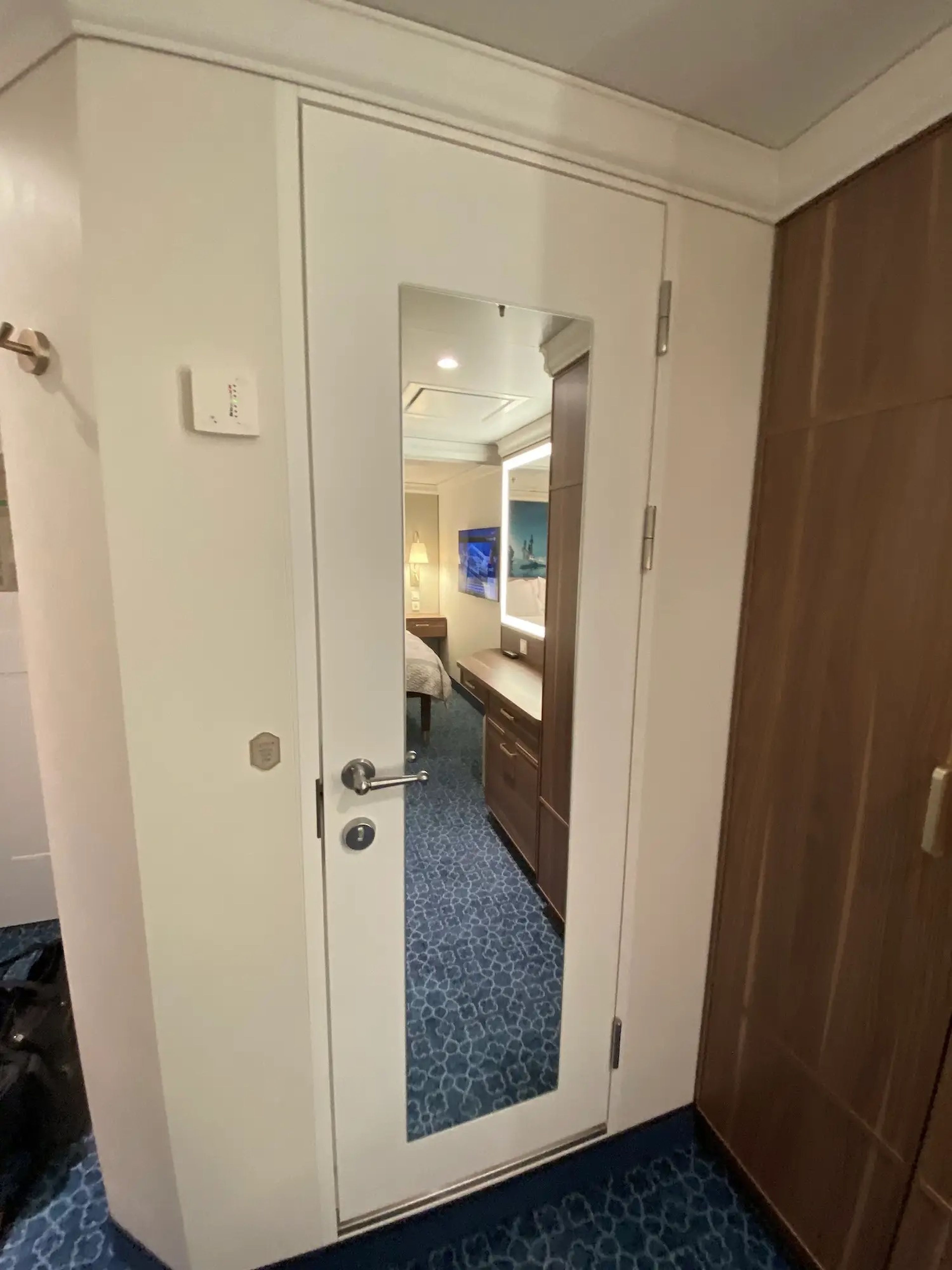 The bathroom door inside a standard stateroom aboard the Disney Wish.