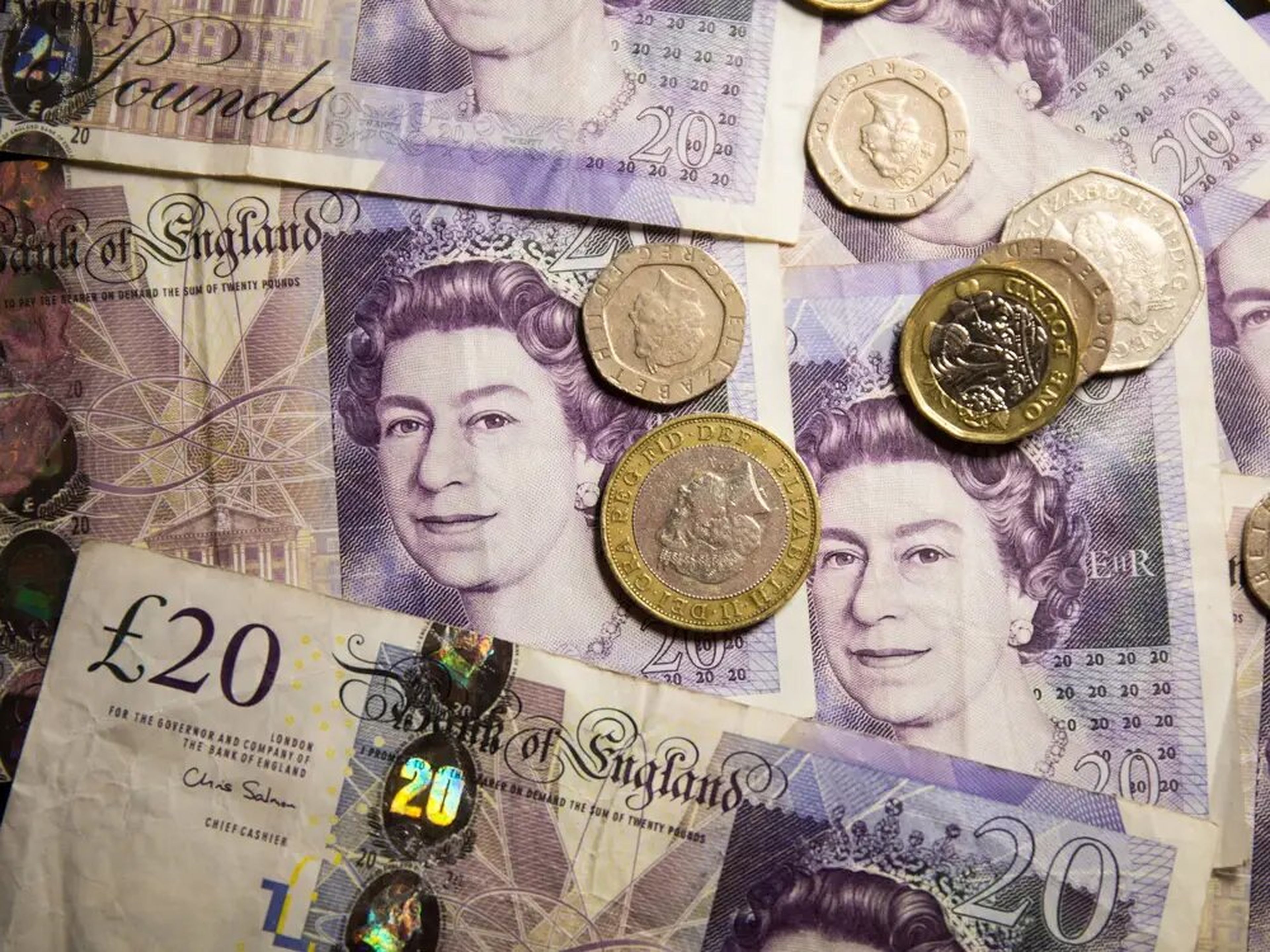 Billetes y monedas británicos con el retrato de la reina de Inglaterra.