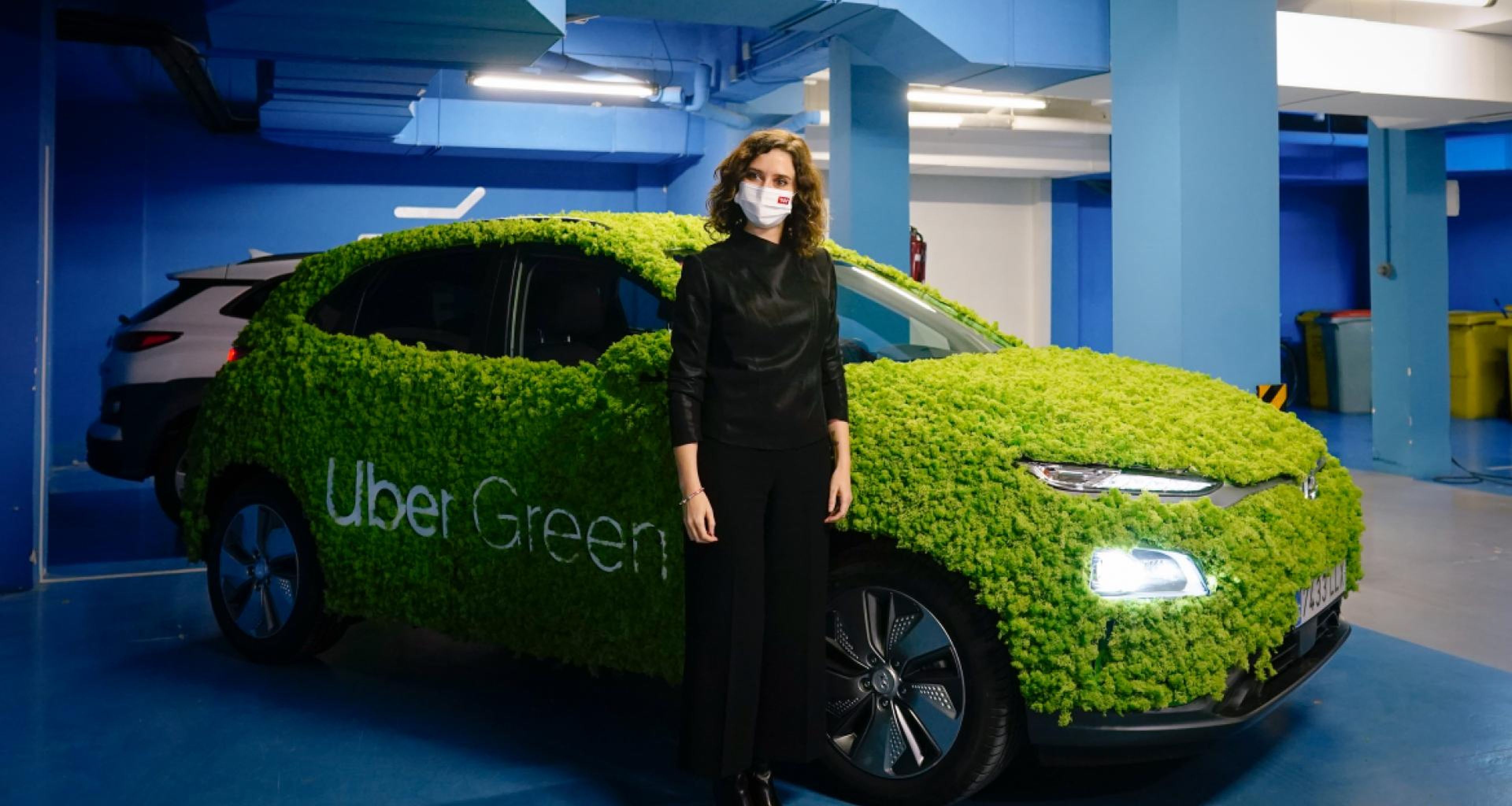 Isabel Díaz Ayuso posa junto a un vehículo de la compañía Uber en un acto promocional.