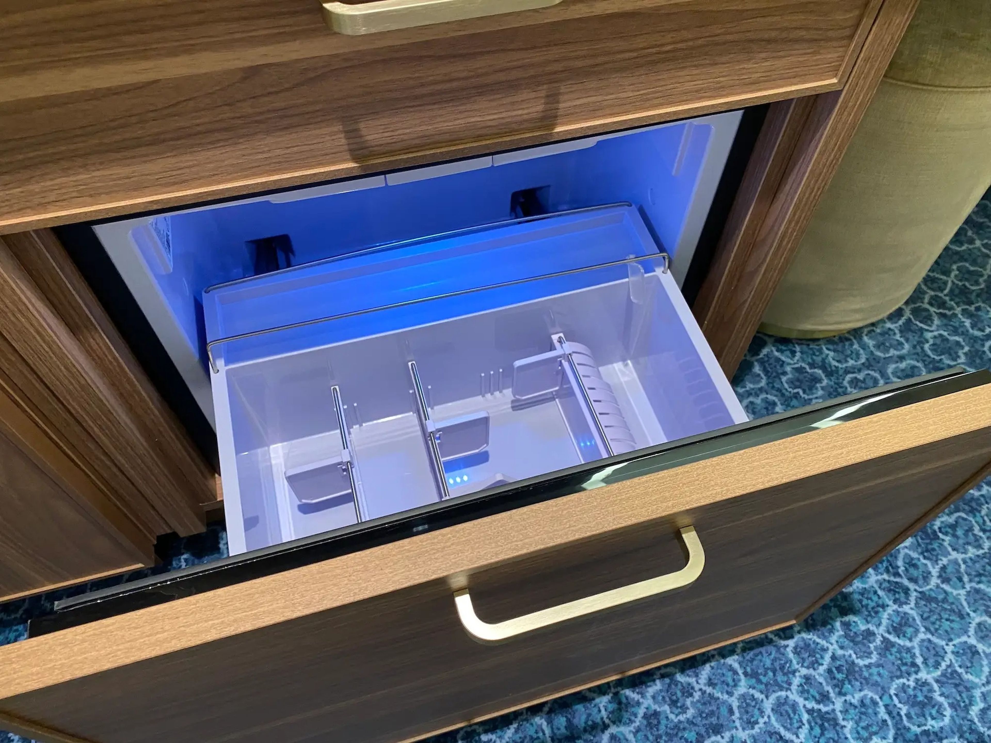 A mini fridge inside a standard stateroom aboard the Disney Wish.