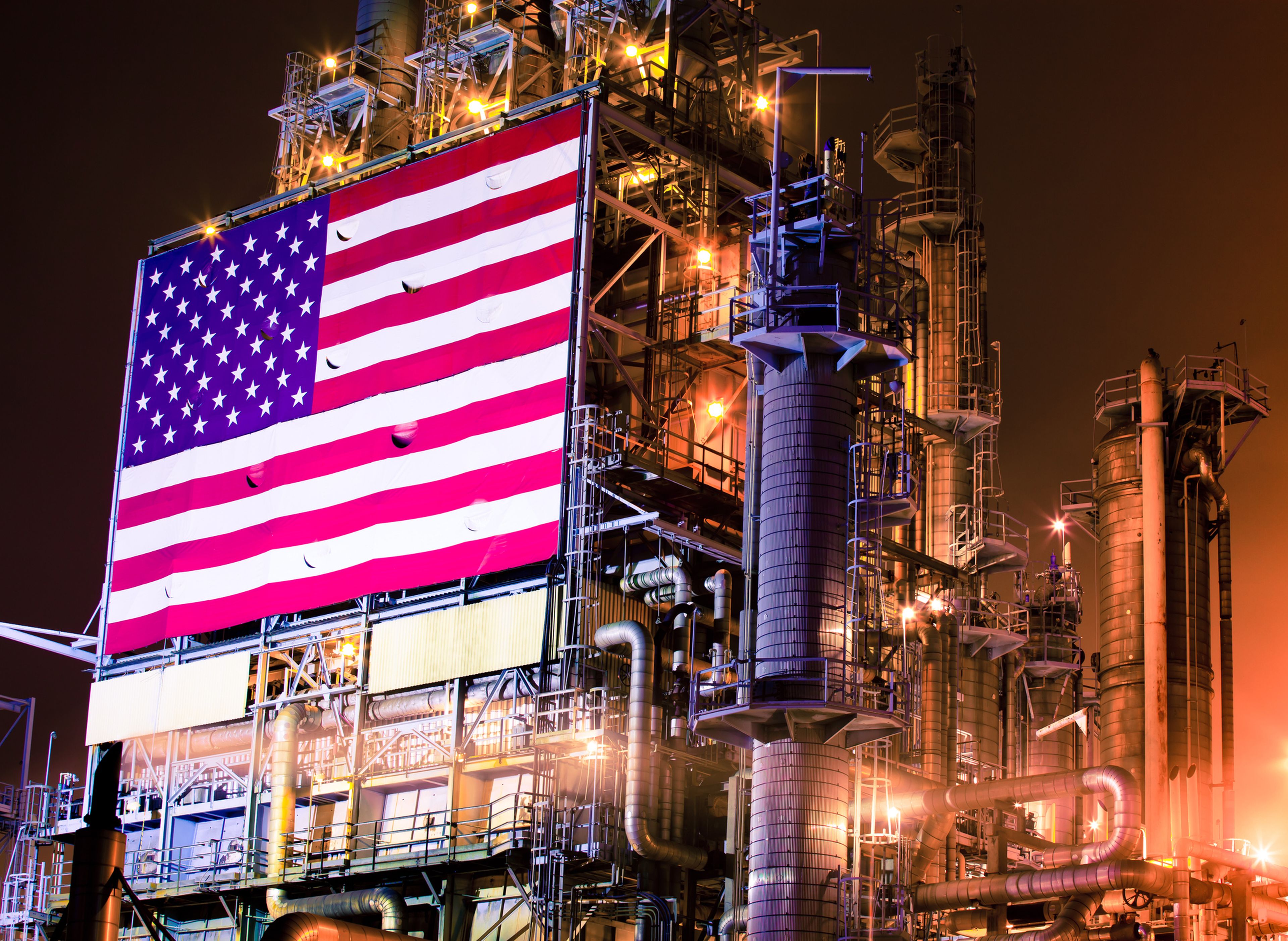 Una refinería de petróleo con una bandera de los Estados Unidos.