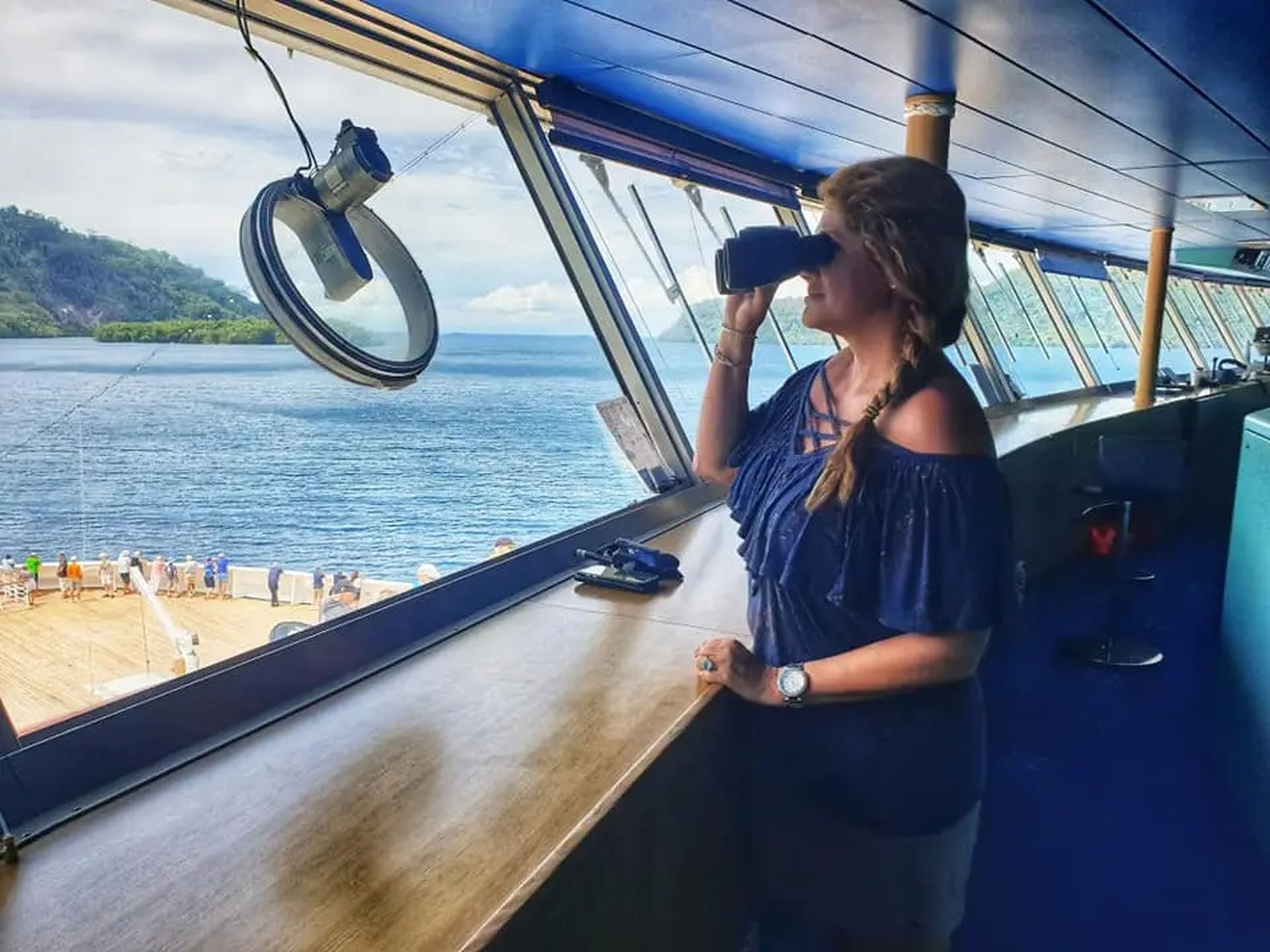 the writer with binoculars looking at a cruise