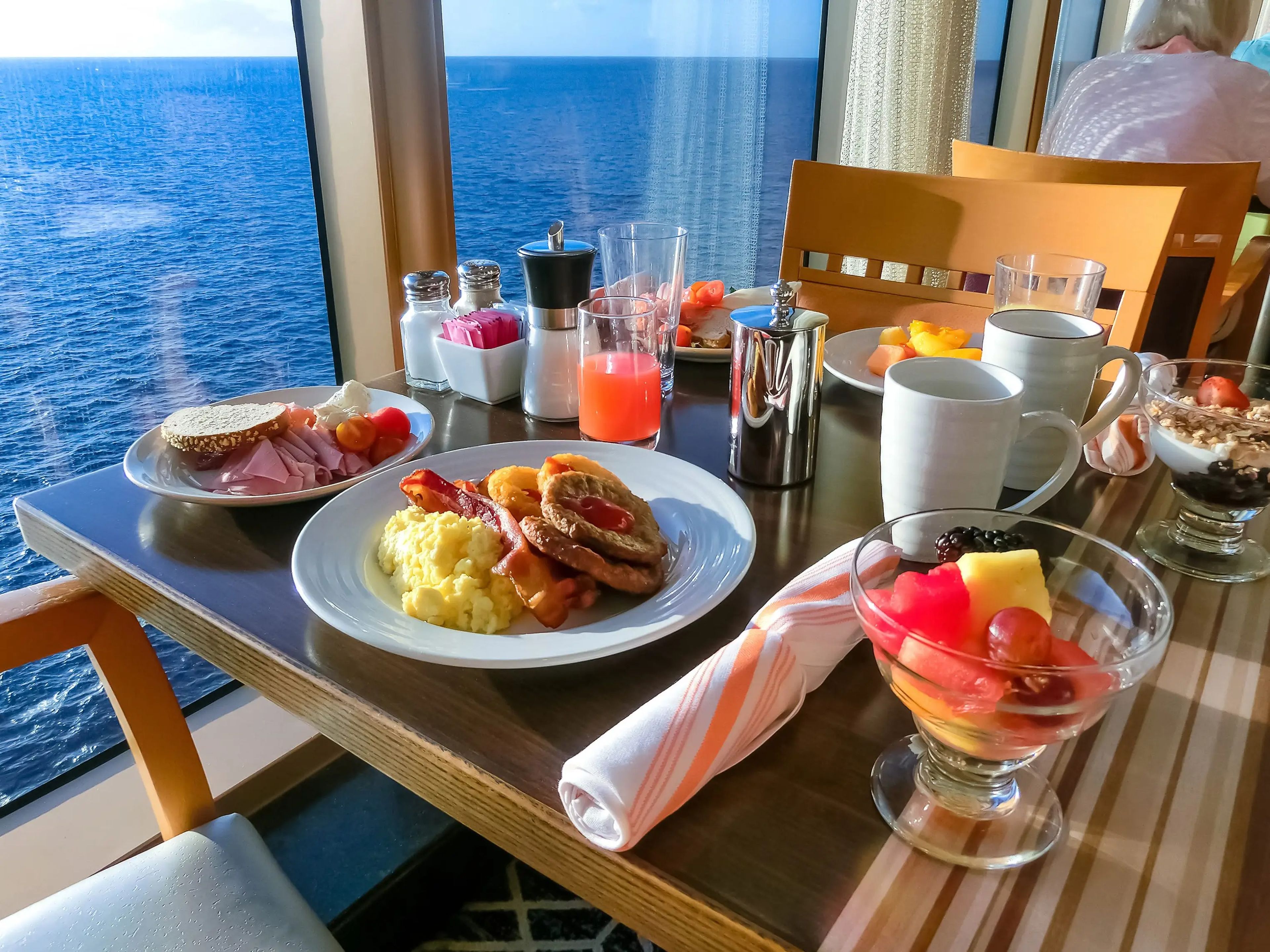 Buffet food on wooden table with ocean view on cruise ship