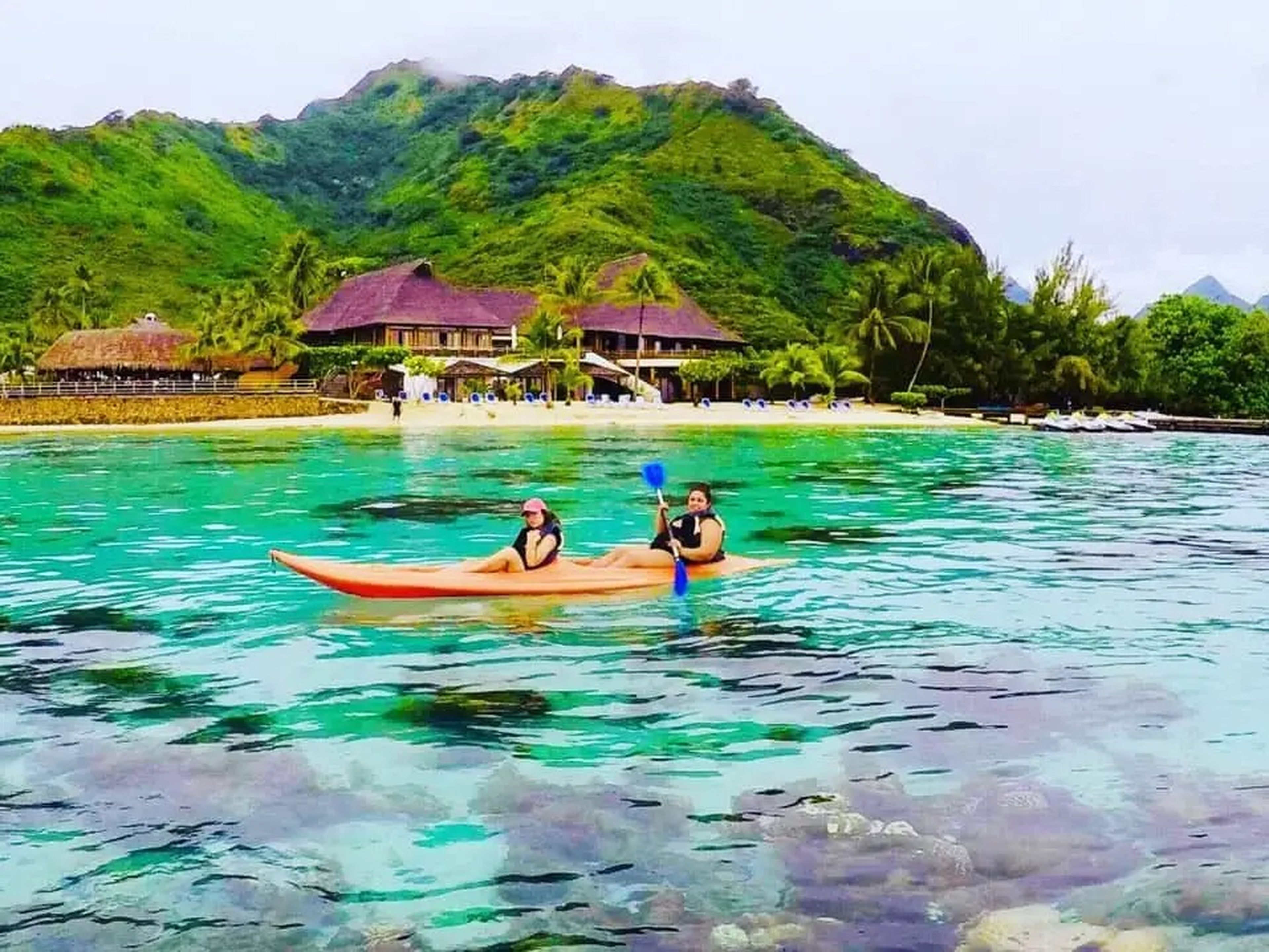 People Kayaking in stunning water of Cooks Bay, Moorea in French Polynesia